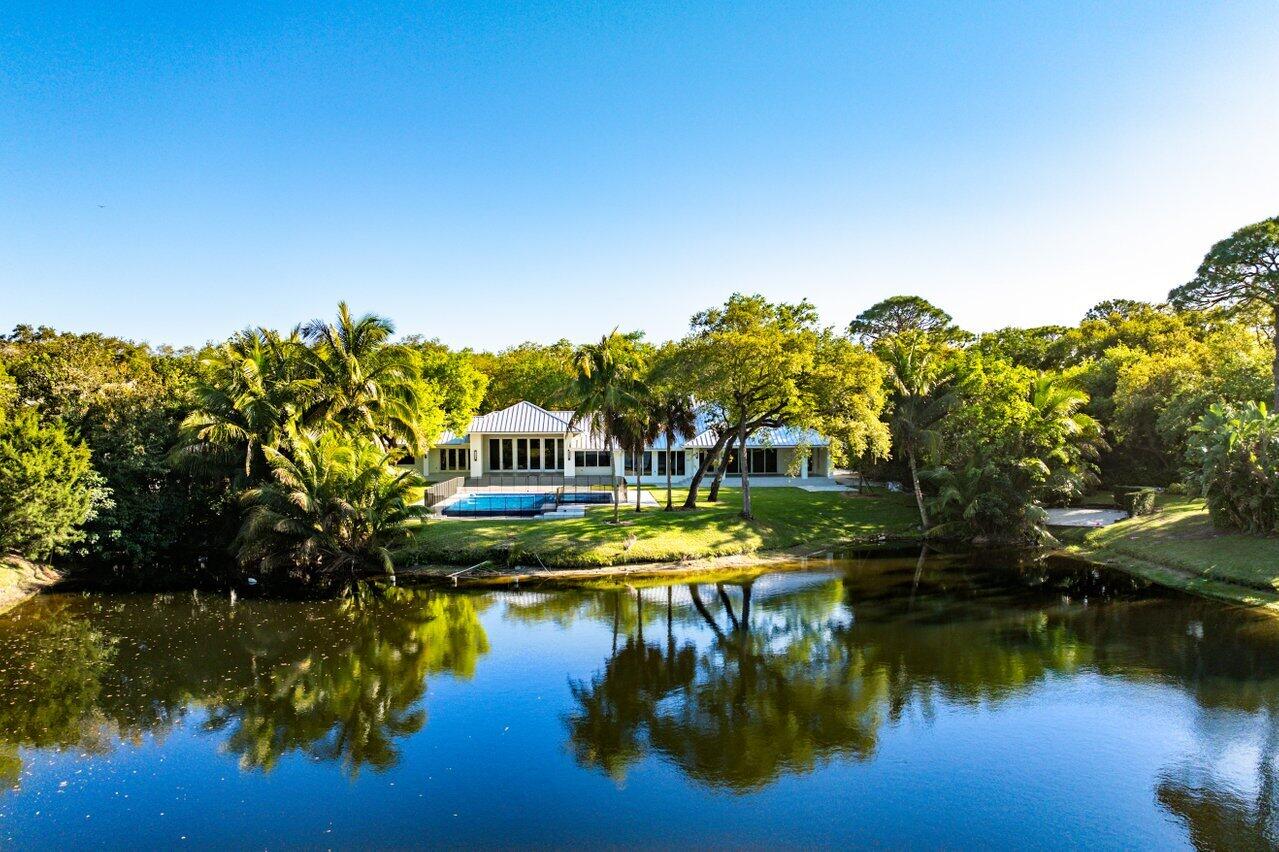 Walk into this residence and be stunned by the beauty of the lake views! 
Experience unparalleled luxury in this fully reimagined estate, situated on the premier, most coveted lakefront lot in Foxe Chase! The only property in the community offering a full length, unobstructed long lake view. This totally rebuilt and expanded home is a true masterpiece! Nestled within the prestigious Foxe Chase enclave of Delray Beach-an exclusive community of just 43 homes, each on a sprawling one-acre lot. This residence offers both privacy and breathtaking surroundings.
Meticulously redesigned, this home was taken down to the concrete shell and completely rebuilt and expanded by 1000 square feet, including all new electrical, all new plumbing, new metal roof, all new impact windows and doors, full house reverse osmosis water filtration, completely new interior throughout and a spectacular new infinity pool and spa. The oversized chef's kitchen is a culinary dream, boasting top-of-the appliances, custom cabinetry, and elegant finishes. Expansive, sunlit living spaces seamlessly connect to the outdoors, where the spectacular new pool and spa overlook the tranquil lake. The home's smart features include smart phone controlled pool, cameras, sound system, AC, and doorbell from anywhere and WiFi extenders throughout the property.
Whether relaxing or entertaining, this private retreat provides an unmatched setting of elegance and serenity.
Foxe Chase offers the perfect blend of privacy and convenience, just 3 miles from the Atlantic Ocean and just minutes away from Delray Beach's vibrant downtown with world-class dining and shopping. This is a rare opportunity to own a fully modernized home on the premier lot in one of South Florida's most desirable communities.
The only part of the house that is original from 1984 (which is what the tax role has as year built) is some concrete shell and trusses for part of the house.