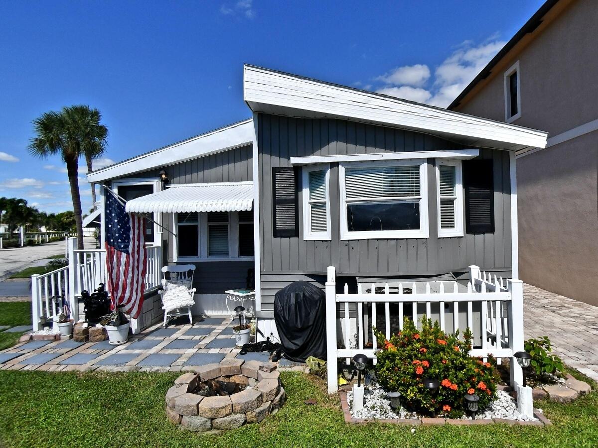 Discover this charming single-story residence located across the street from the beach. This thoughtfully designed home offers 2 bedrooms and 2 full baths.   Your beach home awaits in sunny Hutchinson Island.  There is plenty of parking with room for your golf cart to zip you to a private beach access were you can enjoy plunging into a heated pool, or lounge on the beach with a refreshing drink and sand in your toes. You may use your home as a full time residence, seasonal escape or vacation retreat. Island living is calling with a Motivated Seller awaiting.