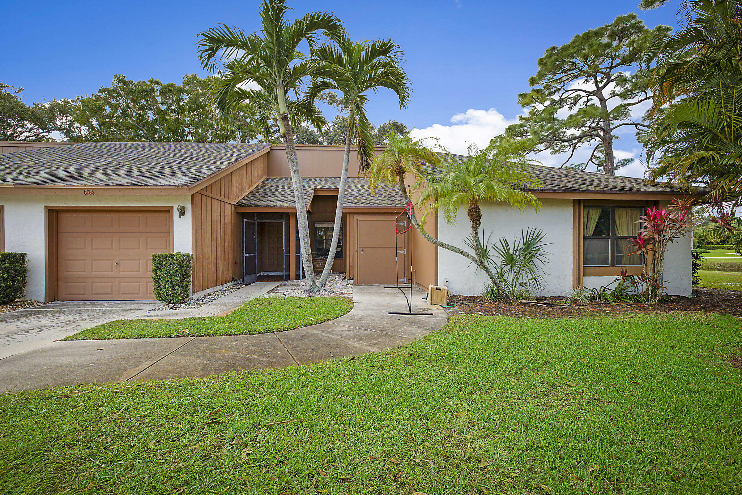 Enjoy breathtaking panoramic lake views from this Eastpointe patio home, offering endless potential in one of the community's most desirable settings. Priced to allow the next owner to personalize and update to their exact taste, this property presents an incredible opportunity for a primary residence, seasonal retreat, investment property, or renovation project.  Nearly every room showcases stunning water views and abundant natural light. The spacious living area is ideal for entertaining, while the oversized screened patio offers the possibility of additional enclosed living space. The kitchen is perfectly positioned to be opened up for an even brighter, more modern layout with expanded lake views.  The generously sized primary suite features beautiful lake vistas and an updated bathroom with tile flooring, a white vanity, and a glass walk-in shower. The oversized guest bedroom includes a walk-in closet, providing comfort and flexibility for visitors or additional living space.  Additional highlights include a one-car garage plus a separate golf cart garage/storage room, newer kitchen appliances (2023-2024), water heater (2021), A/C (2017), and roof (2000).  Located within a community requiring mandatory club membership, this home combines incredible views, great bones, and unlimited potential to create your dream Florida lifestyle.