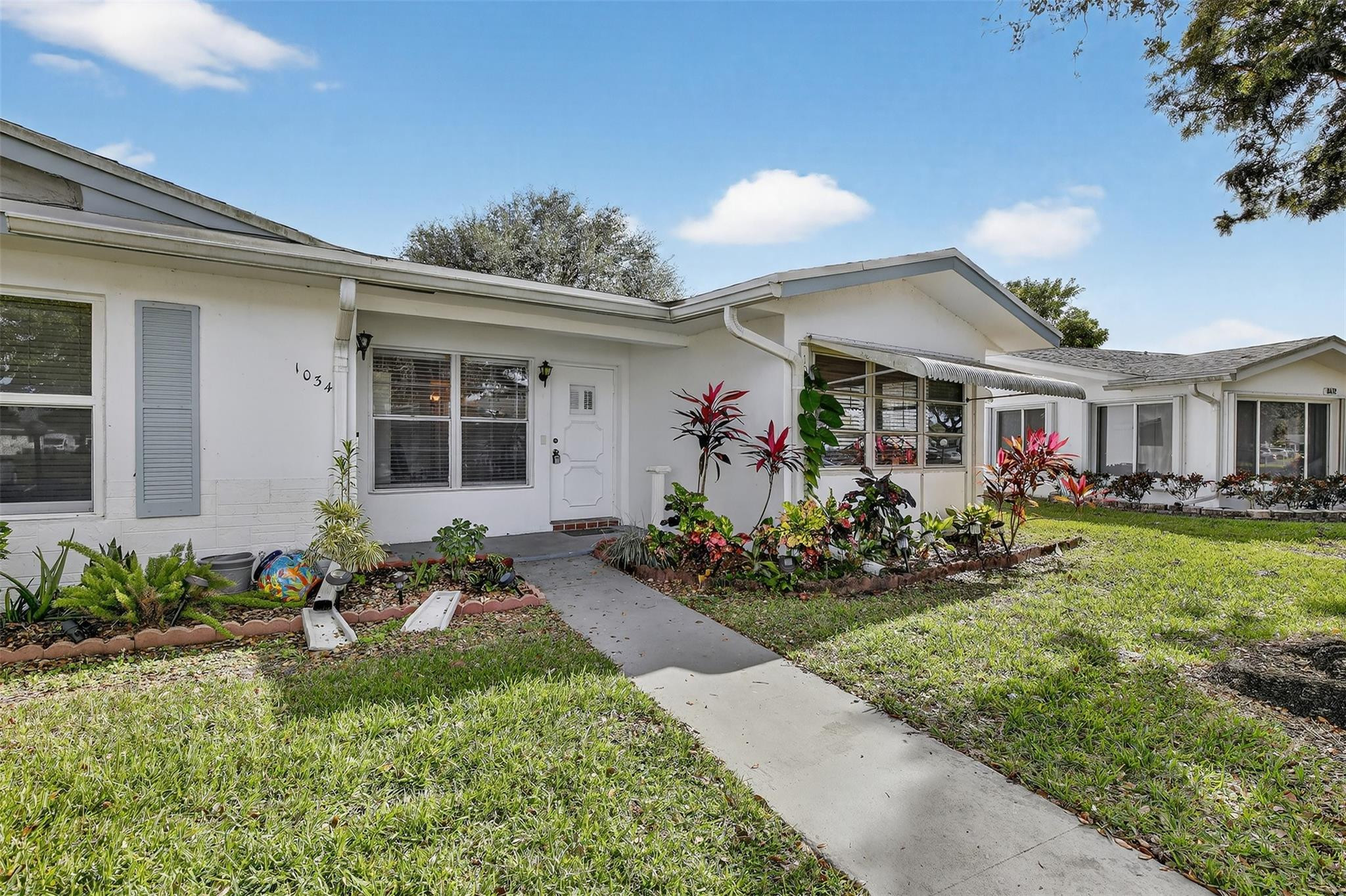 Welcome to your dream home! Nestled on a charming corner lot, this inviting residence boasts a breathtaking lake view that will captivate your heart in LAUDERDALE WEST AN ACTIVE 55+ COMMUNITY. UP DATED KITCHEN WITH NEW REFRIG. DISHERWASHER AND MICROWAVE CABINETS, COUNTERS. Recently refreshed with a fresh coat of paint and new laminated floors, along with NEW blinds. This cozy abode offers spacious closets and an abundance of natural light, creating a warm and welcoming atmosphere. Enjoy the convenience of numerous amenities, including lawn, basic cable, internet,2 clubhouses, pools, tennis counts, fitness center, card rooms, organized clubs, bus service, roof repairs/replacements, exterior painting and pest control. Don't miss the opportunity to make this beautiful property your own!