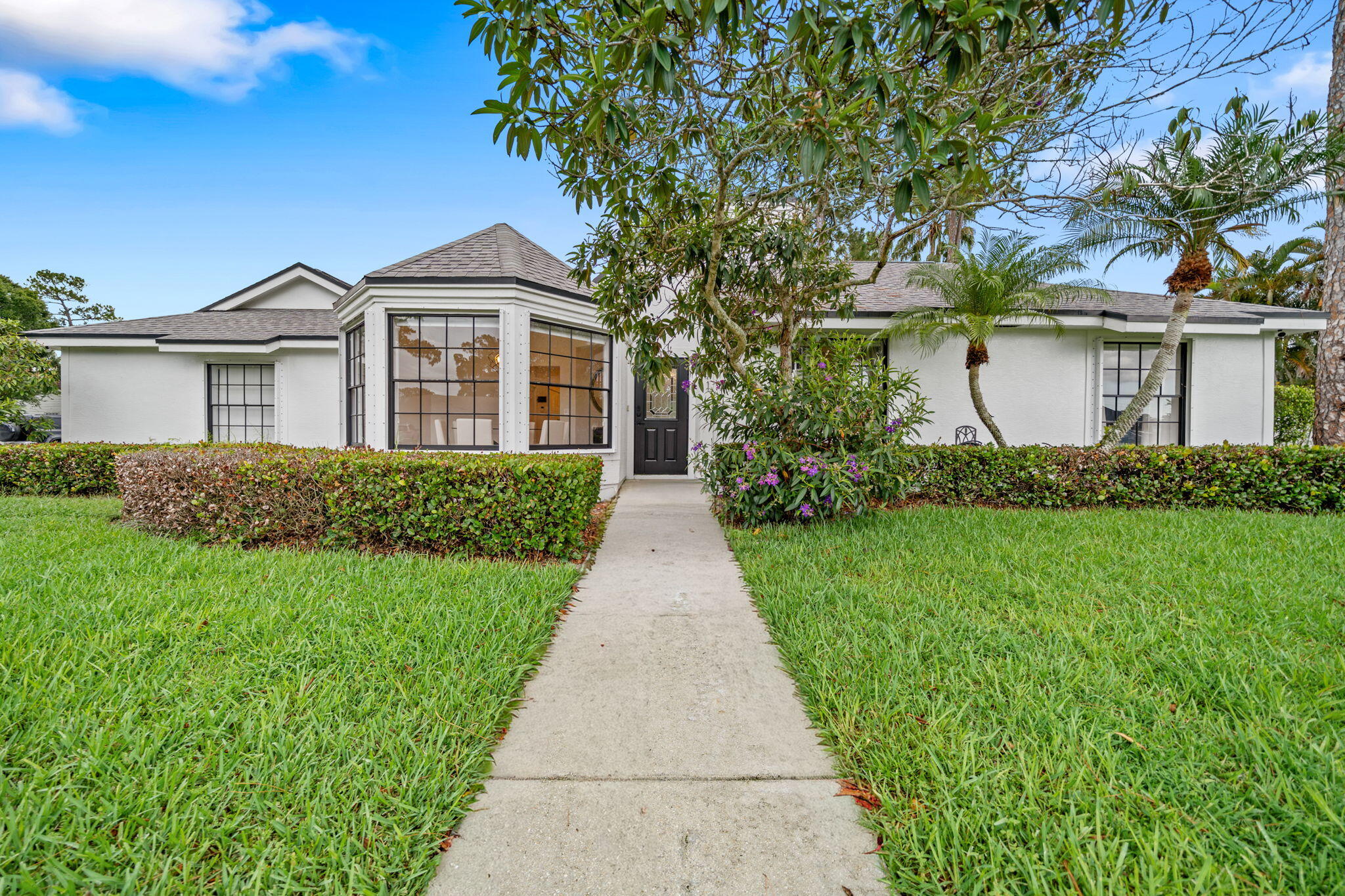 Your ideal Wellington getaway awaits! This beautifully furnished, turnkey 3-bedroom, 2-bathroom home is available for annual, seasonal, or off-season rental and offers everything you need to enjoy the South Florida lifestyle. Situated on a quiet corner lot in the desirable Sugar Pond Manor community with no HOA, this home combines comfort, privacy, and an unbeatable location. Inside, you'll find a spacious split-bedroom floor plan featuring a large primary suite with views of the covered patio, a spa-inspired ensuite bathroom with dual vanities, and an oversized walk-in shower. Two generously sized guest bedrooms and a second full bathroom with a walk-in shower provide plenty of room for family and visitors. The fully equipped kitchen overlooks the breakfast area and private backyard while opening seamlessly into the inviting living room, highlighted by a stunning floor-to-ceiling stone wood-burning fireplace. A separate formal dining room offers the perfect space for hosting dinners and special occasions.  Step outside to your private covered patio and fenced backyard, creating the perfect setting to unwind, entertain, or enjoy Florida's beautiful weather year-round.  Ideally located in the heart of Wellington, you're just minutes from world-class equestrian venues, shopping, dining, parks, golf courses, and top-rated schools. Whether you're planning an equestrian season, an extended vacation, or a year-round stay, this fully furnished home is move-in ready and waiting for you.