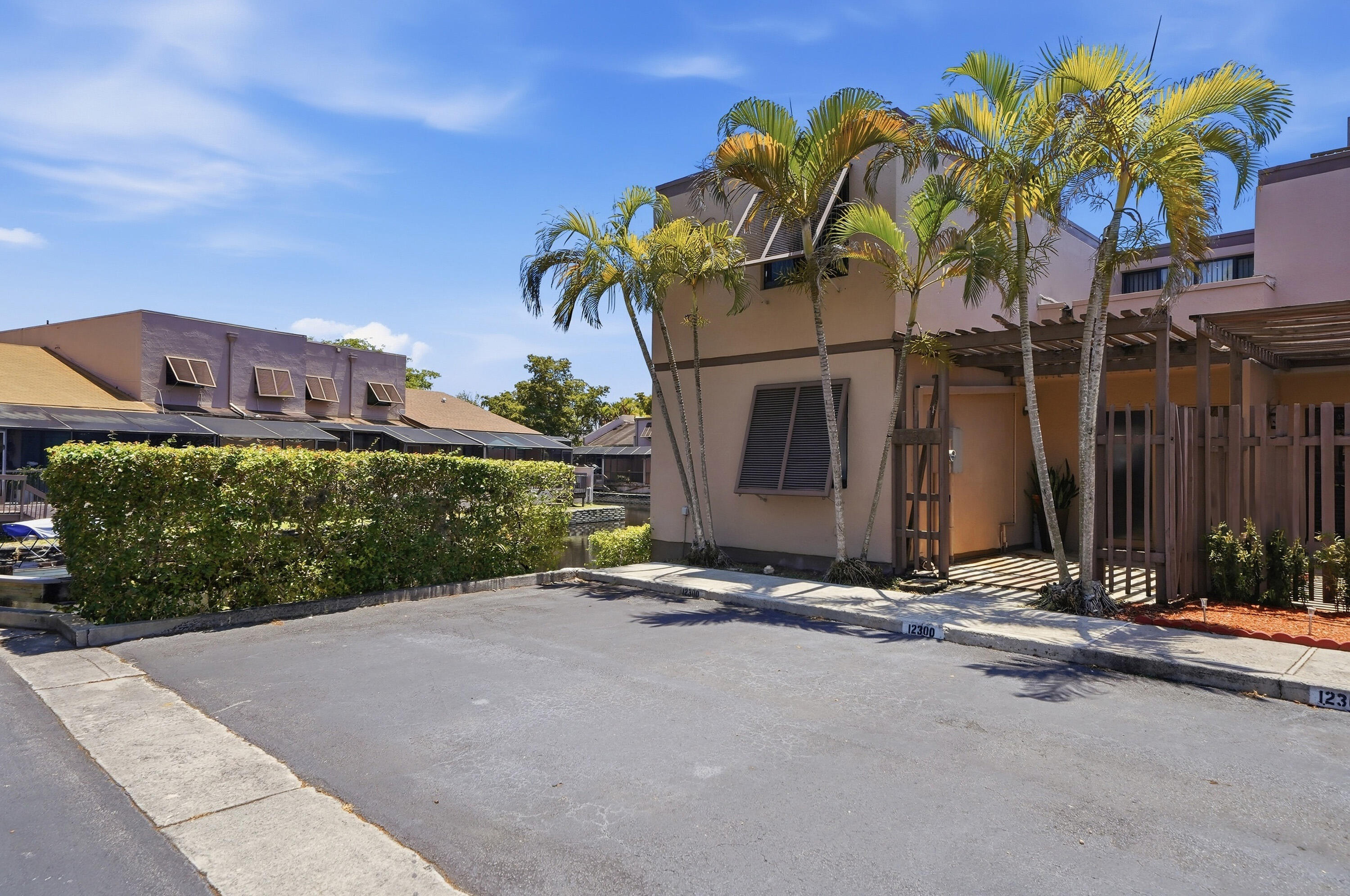 Large corner TH in gated community. Three full bedrooms & three full baths, plus unique water views on 2 sides. Main living space has vaulted ceilings w/ beautiful wood beams & custom wood shelving. Updated kitchen w/ soft-close shaker cabinets, quartz counters, SS appliances, pot filler faucet & more. Dedicated laundry room w/ full size W/D. One full bedroom/bathroom on 1st floor. Updated bathrooms and a mix of tile flooring. Large private screened patio! Ceiling fans in every room.  Roof 2014, A/C 2021, Tankless WH 2016, New copper plumbing  2009, new electric panel 2018, Impact Windows up, Hurricane Shutters down. 2 Community Pools, Tennis Court, Playground. Close to Memorial Hospital-- on their electric grid. Close to shopping, I-75 & turnpike. Pet-friendly and quick approval.