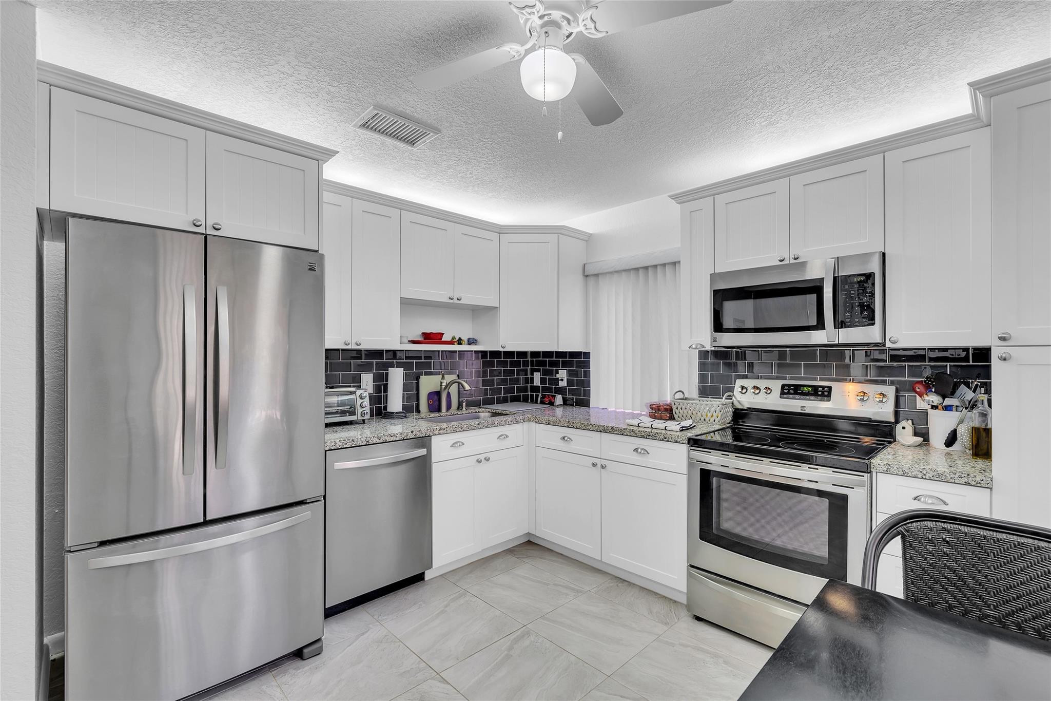 Located in a beautifully maintained cul-de-sac in an upscale 55+ community in Coconut Creek, this 2-bedroom, 2-bath single-family home offers a desirable split floor plan and comfortable, fully furnished living space. Situated in Sawgrass Village II within The Township, residents enjoy access to an array of exceptional amenities, including a community pool, clubhouse, fitness center, theater, racquetball courts, library, and jacuzzi — all included in the HOA. Ideally located at The Promenade in Coconut Creek, you'll have access to shopping, dining, and entertainment. Parks and beaches are just a short drive away, offering the best of South Florida living. This is a fantastic opportunity to enjoy a vibrant lifestyle in a welcoming community. Motivated seller! A NEW ROOF recently installed.