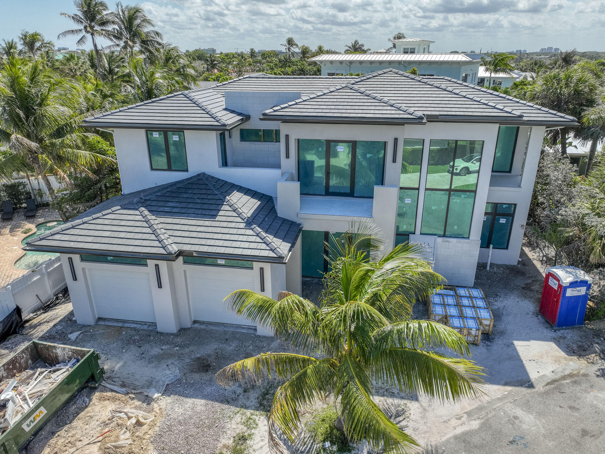 Steps to the beach. Nestled within the highly sought-after enclave of Juno Beach lies this exquisite example of modern new construction. This residence boasts an inviting open-concept design, adorned with luxurious wood flooring throughout and high-end fixtures, promising a lifestyle of both elegance and comfort. With 5 bedrooms, each accompanied by its own en-suite bathroom, this home offers unparalleled convenience and privacy. The upstairs living area has a loft and the rooms have access to three terraces, perfect for soaking in the Florida sun or enjoying evening breezes. Elevator shaft has been built giving you the option of installing. Downstairs, one of the bedrooms presents a versatile space, ideal for use as an office or guest accommodation. The heart of this home is its meticulously crafted kitchen, featuring custom cabinets and an oversized quartz waterfall island, perfect for both culinary pursuits and casual dining. Seamlessly connected to the kitchen is the open living area, boasting a built-in fireplace and offering panoramic views of the outdoor living space through impressive 10-foot sliders.
Step outside and discover an entertainer's paradise, where you can host gatherings with ease in the summer kitchen, or unwind by the poolside oasis complete with a built-in spa. Enclosed within a fenced backyard, this outdoor retreat ensures the utmost privacy, allowing you to fully embrace the serene surroundings.