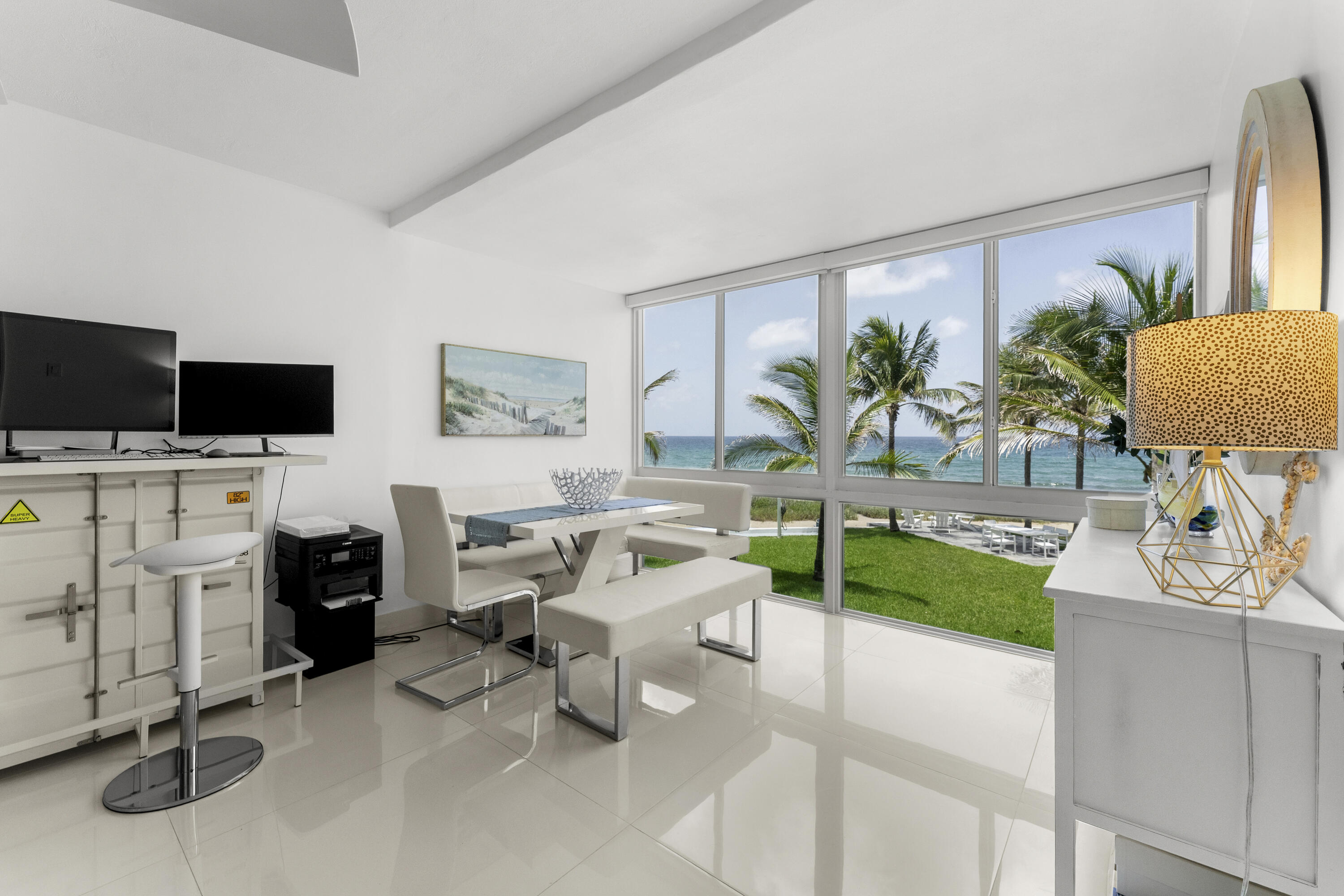 Wake up to endless blue water in this fully remodeled 2-bedroom, 2-bathroom coastal retreat with beachfront views, located in a boutique direct oceanfront building on the coveted Hillsboro Mile. Every inch of this unit has been beautifully updated, offering a modern beach aesthetic with no detail overlooked.  This boutique three-story elevator building has been extensively updated as well, with a brand-new roof and gutters (February 2026), and hurricane-impact windows throughout. Residents enjoy two new oceanfront patios furnished with weather-resistant polywood seating, five boat slips, and a jet ski dock with room to expand, newer common washers and dryers, and approximately 30 years remaining on the land lease.