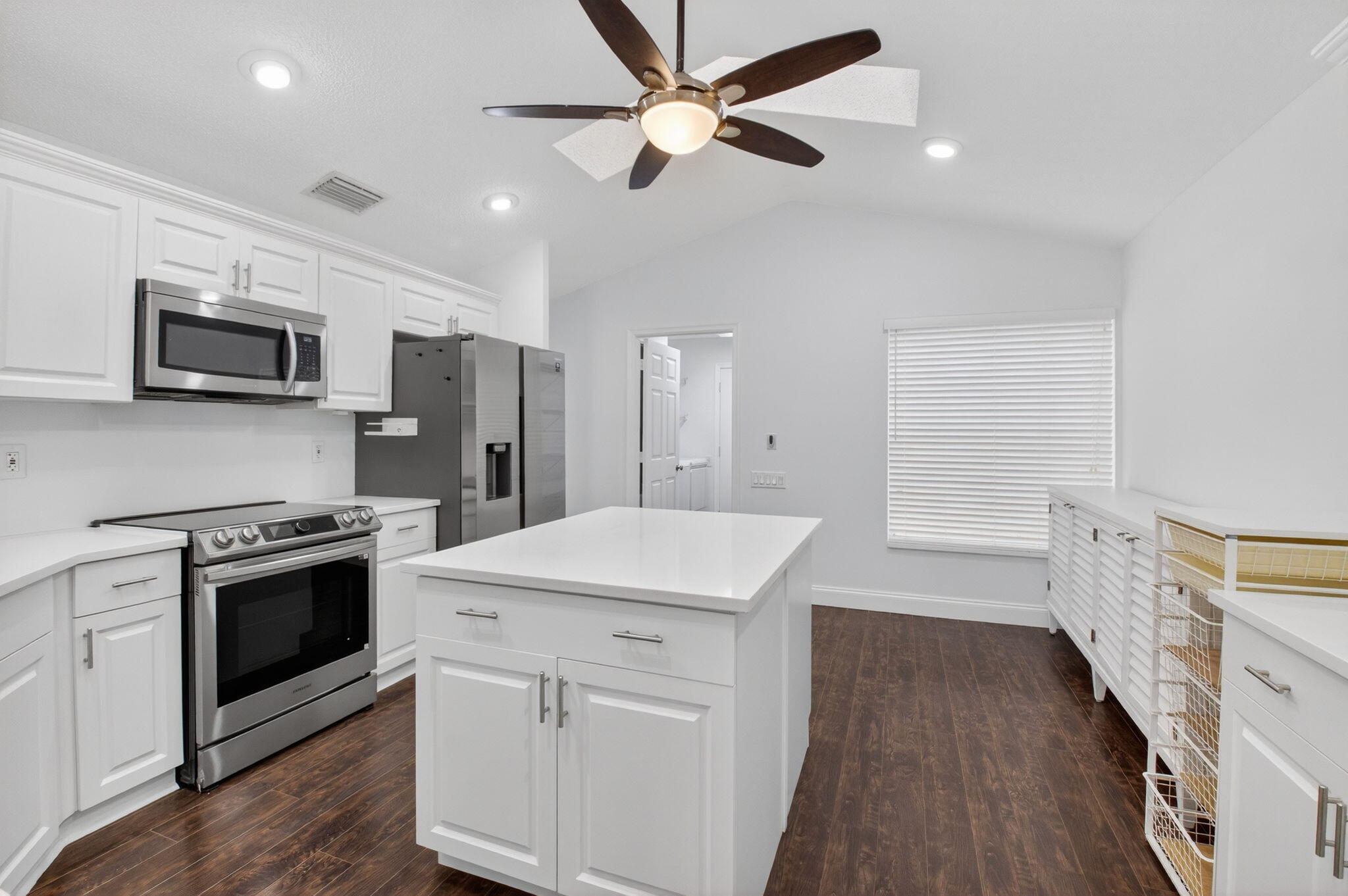 Act fast—seller is offering a $5,000 credit toward closing costs, making this move-in-ready home an exceptional value that buyers won't want to miss. Beautifully updated and designed for peace of mind, it features soaring ceilings, fresh modern paint, all-new plumbing, newer A/C, water heater, and roof, plus full accordion storm protection. The stylish kitchen with newer appliances, renovated bathrooms, sleek laminate and tile flooring, and spacious primary suite with a custom walk-in closet deliver both comfort and style. Outside, enjoy a large Florida room, screened patio, and extended patio ideal for entertaining. Homes with this many upgrades and incentives do not last—schedule your showing now before it's gone!