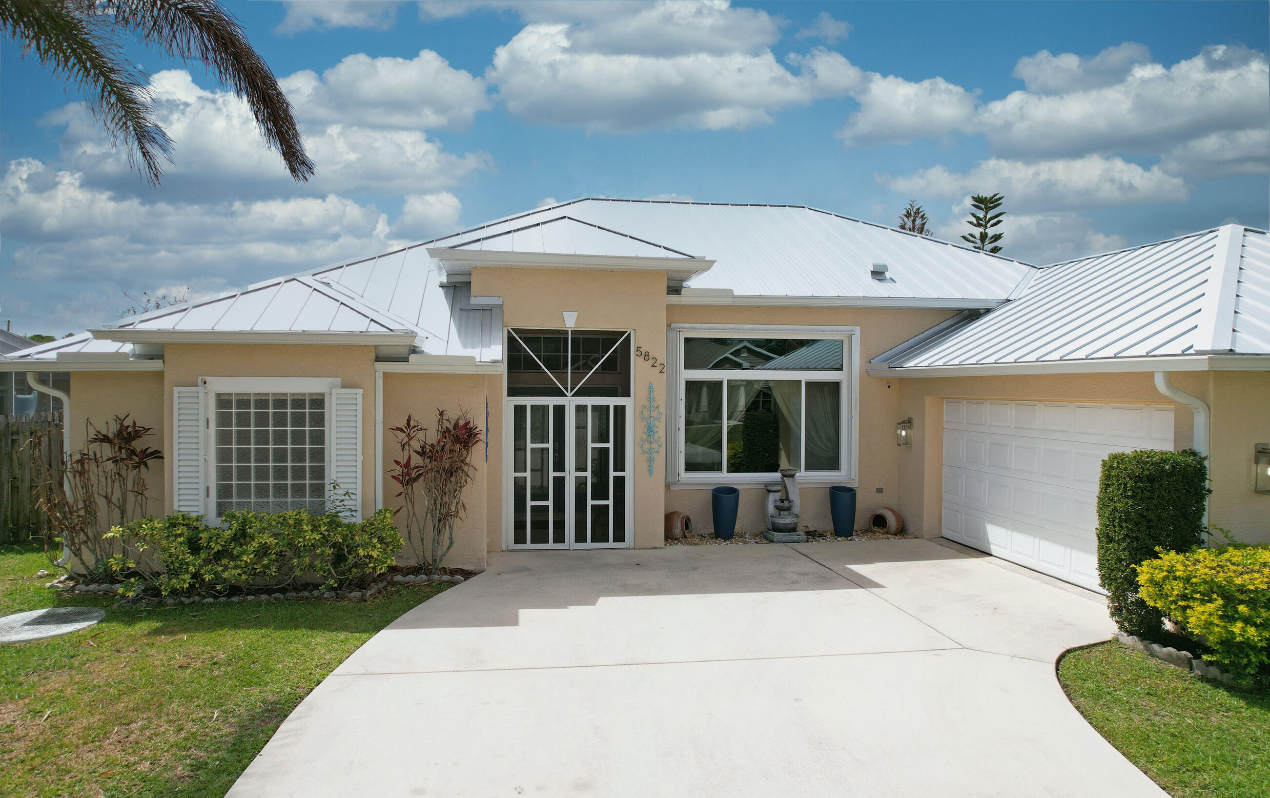 PRICE REDUCED TO SELL!  From the moment you step into this 4 bedrm, CBS home you'll see the attention to architectural detail & meticulous condition of this gorgeous house located in desirable Torino! 2023 METAL ROOF!  NEW WATER HEATER, NEWER AC, ACCORDION SHUTTERS! Including accordions to close in the massive screened, and tiled, lanai!  Updated kitchen and baths, stainless appliances, including double wall ovens! Kitchen cabinets w/pull-outs for easy access storage! Large yard with room for a pool!  GUEST BEDROOM IN THE REAR OF THE HOUSE HAS A PRIVATE ENTRY & WALK IN CLOSET! Enjoy a luxurious European style shower with multiple shower heads plus an add'l overhead rain shower &  hand held European style showerhead,  Watch the fireworks at Mets Stadium while lounging in your own backyard!  NO HOA! Convenient to  St. Lucie West, Clover (Mets) Stadium, new 195 acre Torino Regional Park, pickleball courts, skating rink, splash pad, walk/bike trails, forest playground and more!  Room sizes are approximate.  Buyers to verify.