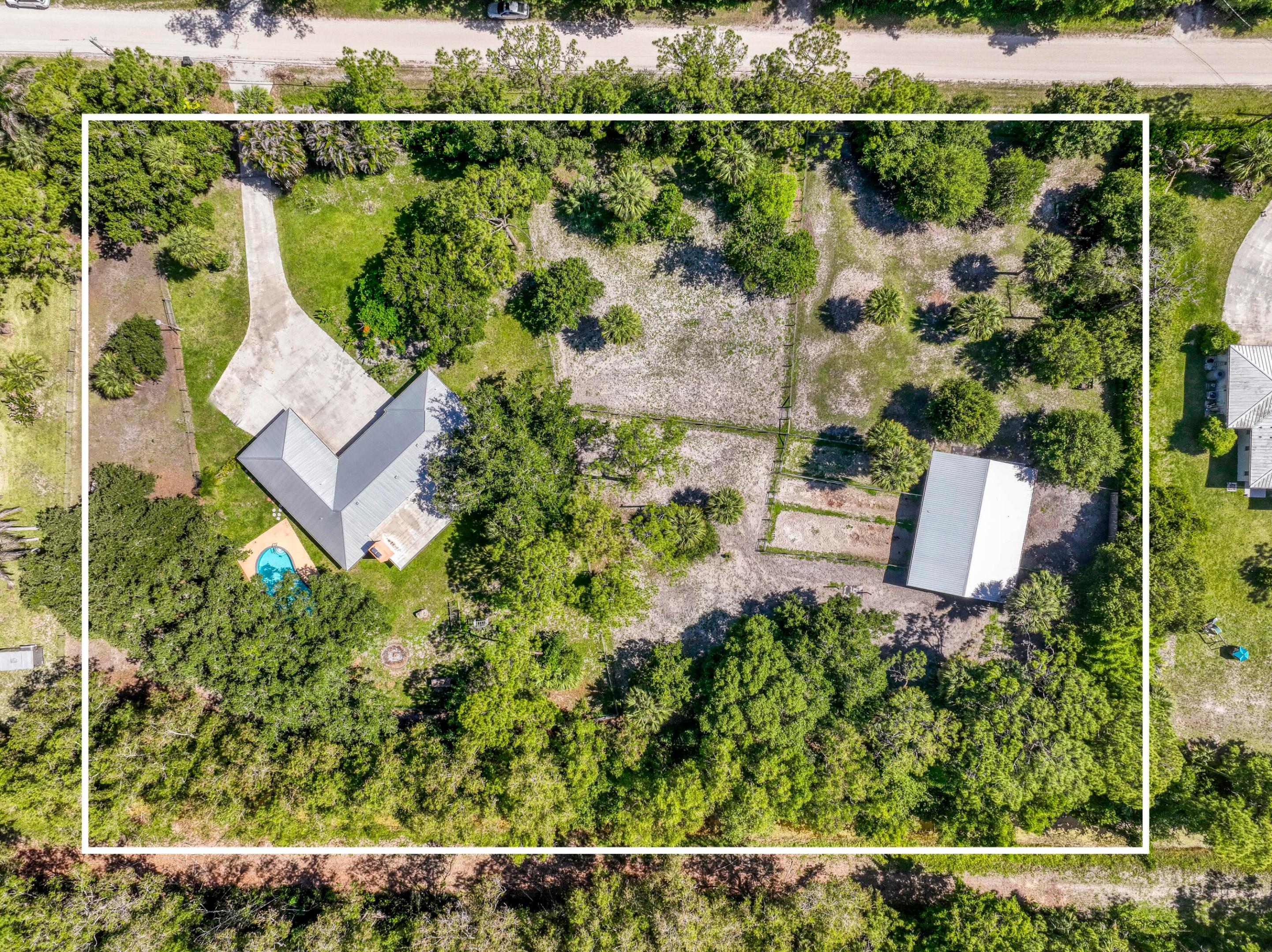 Wake up in the morning to the view of your horses on this fully fenced, 2.54 acre equestrian property! Custom barn built in 2018 hosts 6 stalls with fans, 5 run outs, feed/tack room, storage room, fully permitted water and electric, and security cameras. As your horses roam 4 pastures without neighbors directly behind, enjoy your single-level sanctuary: 3 bedrooms, updated kitchen and bonus Florida room give you space to entertain or spread out. Cozy up to the wood burning fireplace when it gets cold, or go outside and take a dip in the pool when it's warm. Raised garden beds and an ultra deep fire pit complete the property. House is protected by full impact glass and metal roof (9 years young). Walk your horses on the dirt roads surrounding the property or take them to enjoy the trails of Riverbend Park. Jupiter Farms is a no-HOA agricultural/residential community 20 mins to the beach, 5 minutes to I-95 and the Turnpike, 30 minutes to PBI.