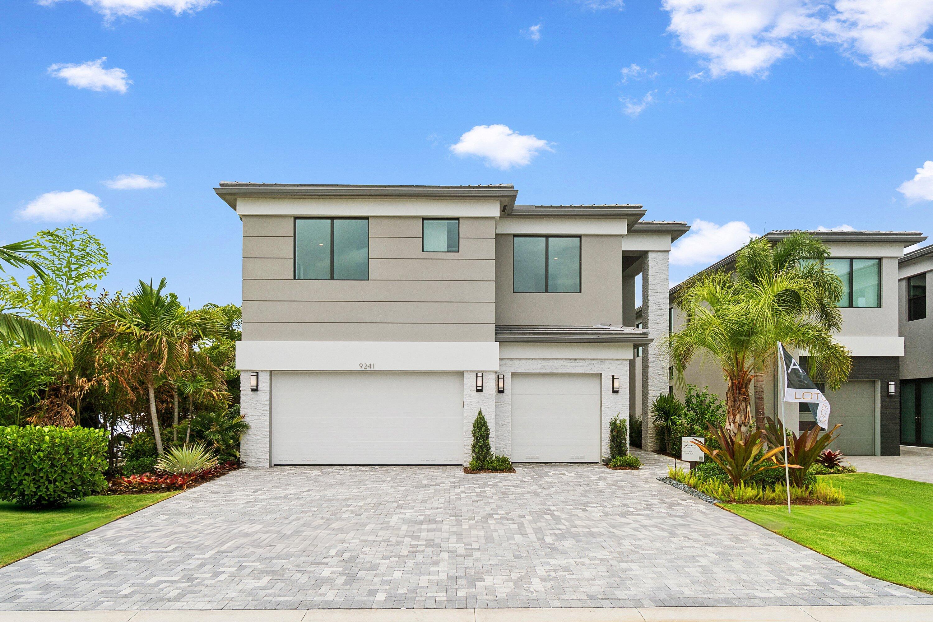 Brand new and never lived in, this stunning Honolulu model in Lotus Edge showcases the perfect blend of luxury, style, and modern design. Offering 5 bedrooms, 5 full bathrooms, a spacious loft, and a 3-car garage. Professionally curated by a designer, every upgrade and finish was carefully selected to create a sophisticated, cohesive aesthetic that feels both timeless and elegant. Step inside to discover soaring ceilings, smooth-finish walls and ceilings, abundant recessed lighting, and stunning 24" x 24" polished porcelain flooring throughout the main living areas. The open-concept floor plan is flooded with natural light and designed for both comfortable everyday living and effortless entertaining. The chef's kitchen is a true showpiece, featuring a 48-inch built-in GE Profile  refrigerator, 36-inch natural gas cooktop, double ovens, highly upgraded cabinetry, designer hardware, quartz countertops, and an oversized island that serves as the heart of the home. A stylish wet bar adds the perfect touch for entertaining guests. The luxurious primary suite offers a private retreat with beautiful engineered white oak flooring and a spa-inspired bath complete with a freestanding soaking tub, seamless glass shower enclosure, premium Toto fixtures and custom quartz countertops. Upstairs, the expansive loft provides flexible living space ideal for a media room, home office, fitness area, or playroom. Thoughtfully equipped for future outdoor living, the home includes a gas stub for a future summer kitchen, pool and spa pre-wiring, widened driveway, upgraded marble slate paver entry and patio, Cat6 wiring, security system, gas dryer, and a tankless natural gas water heater. Located within the highly sought-after gated community of Lotus Edge, residents enjoy access to a spectacular brand-new clubhouse featuring resort-style amenities, an expansive pool, state-of-the-art fitness center, tennis and pickleball courts, social spaces, and an active lifestyle program. Conveniently located near Boca Raton's premier shopping, dining, entertainment, beaches, and top-rated schools, this extraordinary residence offers the rare opportunity to own a brand-new luxury home without the wait of new construction. Move right in and enjoy designer-curated luxury, modern convenience, and the exceptional lifestyle that Lotus Edge has to offer.
