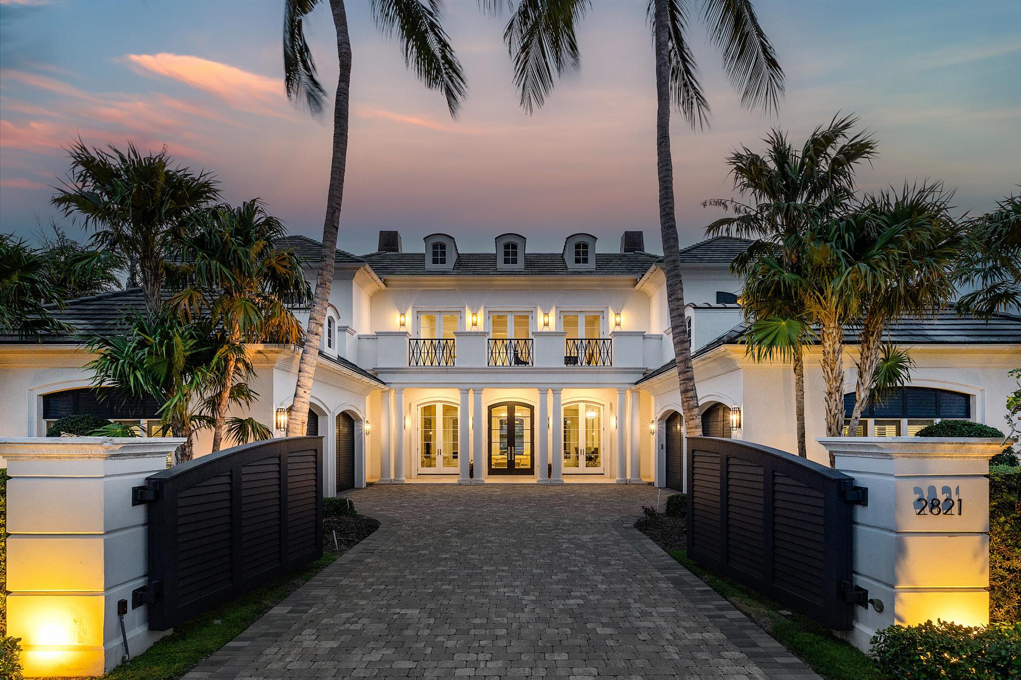 Architectural Masterpiece on the Water

This one-of-a-kind waterfront estate blends bold architecture with timeless design across more than 12,000 square feet of meticulously curated interiors. Every element—from the rich stonework and custom millwork to the dramatic lighting and elevated finishes—was intentionally crafted to deliver both form and function. With 5 bedrooms, 6 full bathrooms, 3 powder rooms, an elevator, and multiple indoor and outdoor entertaining spaces, the home sets a new standard in luxury living. Main Level
A grand mahogany entry opens to unobstructed water views, drawing the eye through expansive formal living and dining rooms. Anchored by a fireplace wrapped in floor-to-ceiling King Wood marble, the living area flows seamlessly onto a deep verandah perfect for entertaining. A sculptural staircase with hand-forged ironwork leads upstairs, while a private club room/library offers a coffered ceiling, custom built-ins, and a full walk-in bar. The kitchen is a chef's dreamcomplete with Calcutta Gold marble countertops, bespoke cabinetry, a full butler's pantry, and top-tier appliances. The adjoining family room and breakfast area open directly to the outdoor pavilion, ideal for effortless indoor/outdoor living.

Second Level
Upstairs, a resort-style lounge deck creates the feel of a private hotel retreat, with limestone fireplace and panoramic water views. The primary suite spans the entire waterfront wing and includes dual balconies, a Palladio marble fireplace, two fully built-out dressing rooms, and separate spa bathshers featuring a soaking tub and radius cabinetry, his with a steam shower and marble finishes. A separate VIP suite offers its own balcony, sleek paneled walls, and a hidden entry to the en-suite bath. Three additional guest suites, each with walk-in closets and private baths, complete the level, along with a full-size laundry and utility room.