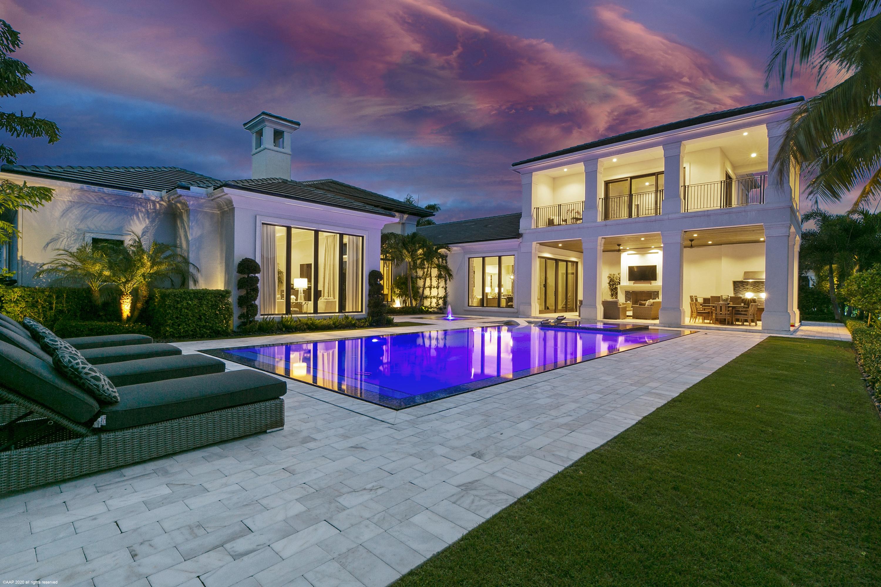 Stunning Custom Bentley floor plan on very desirable 1/2 acre home site with gorgeous golf and lake view.  This incredible estate boasts a formal living room with custom fireplace, custom wine wall fit for any wine enthusiast, light and bright kitchen with top of the line appliances, custom cabinets & quartz counter tops.  The theater room is perfect for watching a new release on a Friday night with the family.  Guests will be spoiled in the VIP guest suite featuring a morning 
bar, expansive wrap around terrace and views of paradise. Working from home won't be an issue as this home features a handsome office with custom built ins & large windows for natural lighting.  The luxurious owner's suite features his and her walk in closets and spa like bathrooms, a pretty sitting area with fabulous views of the tropical backyard, lake and golf course.  Featuring both formal and informal living and dining areas makes this estate home perfect for entertaining!  
Other features- whole house generator, smart home technology, motorized screens on the patio.