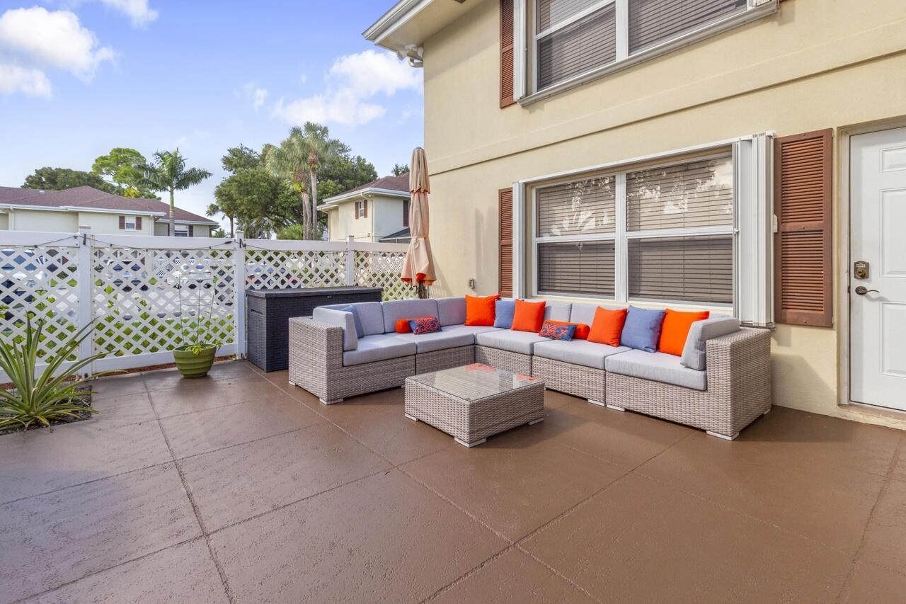 Beautiful 2-bedroom, 2.5-bath townhouse in the heart of Royal Palm Beach offering an open-concept layout with modern finishes throughout. The renovated kitchen features white shaker cabinets, granite countertops, stainless steel appliances, subway tile backsplash, and a breakfast bar overlooking the spacious living area. Upstairs, both bedrooms include private en-suite bathrooms, highlighted by a luxurious primary suite with a frameless glass shower and dual-sinks. Enjoy the convenience of a first-floor half bath with full-size washer and dryer, abundant natural light, and an oversized private fenced patio that's perfect for relaxing or entertaining. Ideally located near parks, shopping, dining, schools, and major roadways, this move-in-ready home combines style, comfort, and convenience.