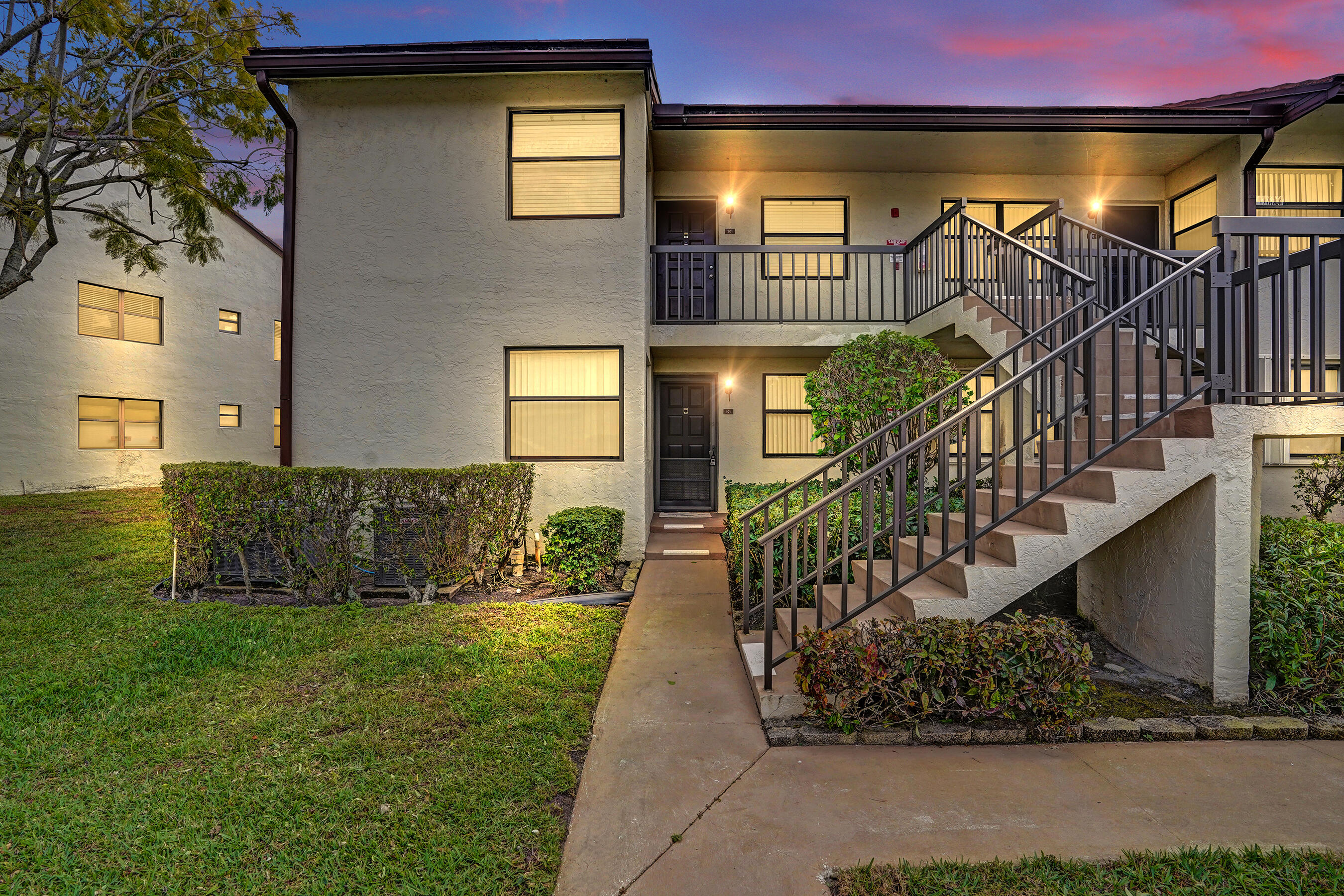 Recently updated ground-floor corner waterfront condo in the Lucerne Pointe community, offering modern finishes and convenient first-floor access. The new kitchen features granite countertops, stainless steel appliances, and updated cabinetry. Laminate flooring runs throughout, complemented by updated bathrooms including a primary bath with step-in shower, modern vanities, and new lighting fixtures. Corner location provides added privacy and natural light. Lucerne Pointe residents enjoy amenities including a pool, spa, tennis courts, and fitness center. Enjoy the screened lanai for outdoor living, with the washer and dryer conveniently located inside the unit. Located near shopping, dining, and major roadways.
