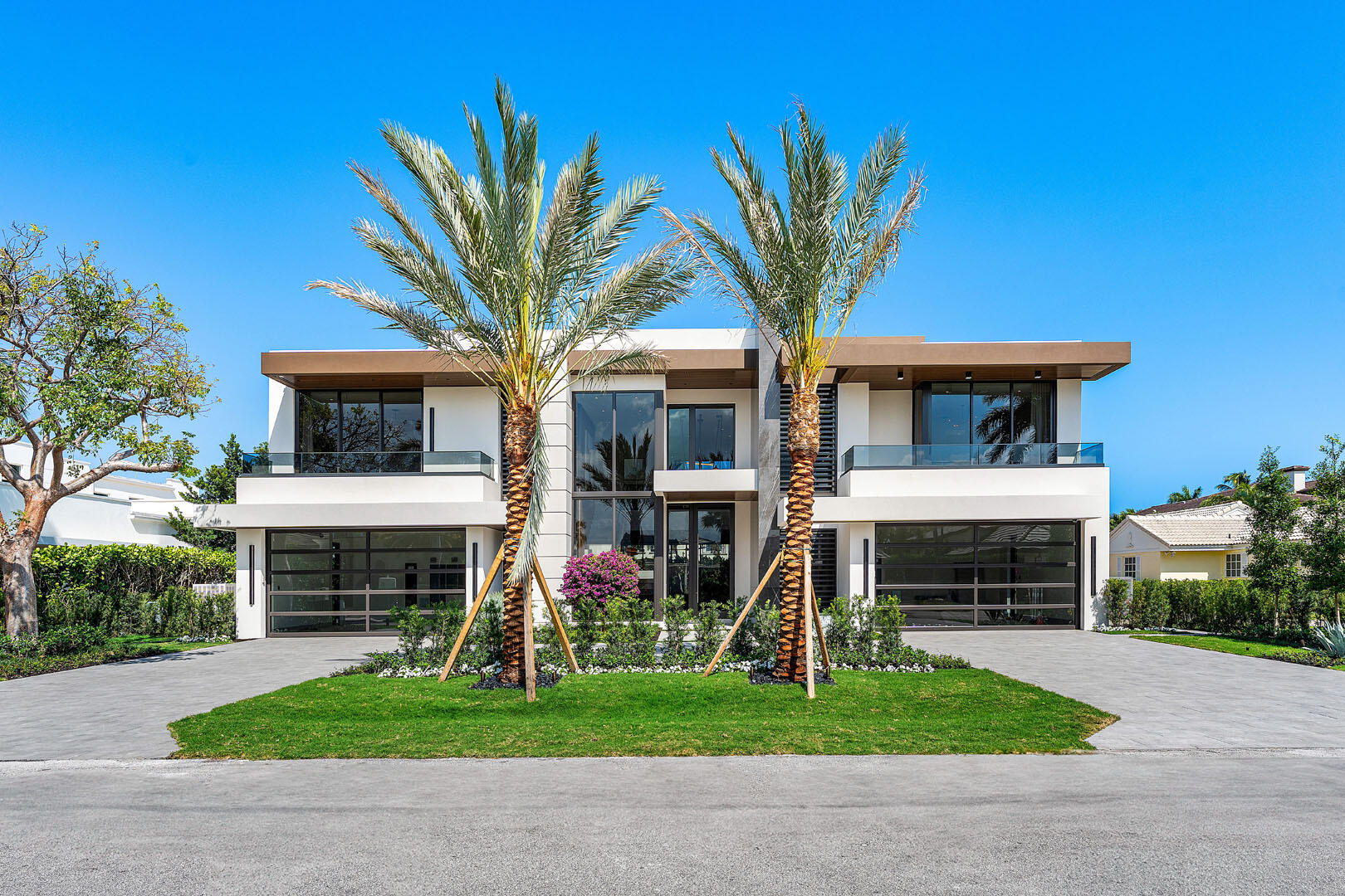 A masterpiece of modern luxury, this brand-new estate is conveniently appointed near the Royal Palm Yacht Club, and showcases exceptional craftsmanship by National Custom Homes, striking architecture by Brenner Architecture, and sophisticated interiors curated by the award-winning Michael Gray Interiors. Offering over 7,000 square feet of impeccably designed living space, this turnkey residence is the pinnacle of refined living. The grand entry sets the tone for an interior with clean lines, exquisite materials, and seamless indoor-outdoor integration. The gourmet eat-in kitchen, paired with a well-appointed butler's pantry, is designed for intimate gatherings and grand entertaining. A stunning club room with a designer bar and cabana bath, along with a private home office featuring custom built-ins, offers spaces for both leisure and productivity. Five elegantly appointed bedroom suites include a primary retreat with dual spa-inspired baths and dressing rooms. Smart home automation, impact windows and doors, an elevator, and a whole-house generator ensure convenience and security.

Outdoors, the resort-style backyard is a private oasis, complete with a breathtaking pool and spa featuring dual sun shelves, a covered loggia, and multiple patios with a built-in BBQ perfect for effortless entertaining. Designed for those who appreciate the finest in luxury and style, this newly constructed estate presents an unparalleled opportunity to own a home of distinction in one of South Florida's most coveted enclaves. The buyer is responsible for documentary stamp taxes on the deed and title insurance.