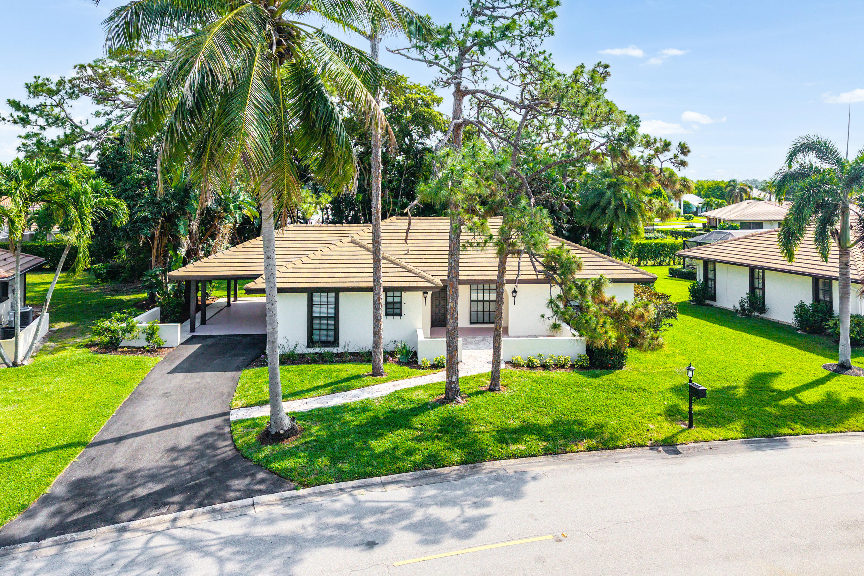 Welcome Home to your newly renovated 2-bed / 2-bath single family home in the heart of Palm Beach County's charming city of Atlantis. Over 2,000 square feet of living space, open concept with split bedrooms and beautiful luxury vinyl floors throughout. Tastefully done kitchen and baths with a sizable primary bedroom including two walk-in closets! Roof 2021, AC 2019 sited on over a 10,000 sqft Lot! Move right into this charming home with an OPTIONAL membership to Atlantis' Country Club or play inside your own golf community at its public course! Nestled in the heart of Palm Beach County, the City of Atlantis is a unique, non-mandatory country club, gated community renowned for its quiet elegance, safety, and resort-style lifestyle.  At the center of it all is The Lost City Golf Club - a private, 27-hole championship course known for its pristine fairways and welcoming yet refined atmosphere. Home to fewer than 2,500 residents, Atlantis is cherished for its privacy, lush landscaping, and two golf courses that wind gracefully through the community, offering rolling greens, shimmering lakes, and mature trees. A rare gem in South Florida, the City of Atlantis offers the perfect blend of exclusivity, natural beauty, and convenience. This one is truly .. A must see!
