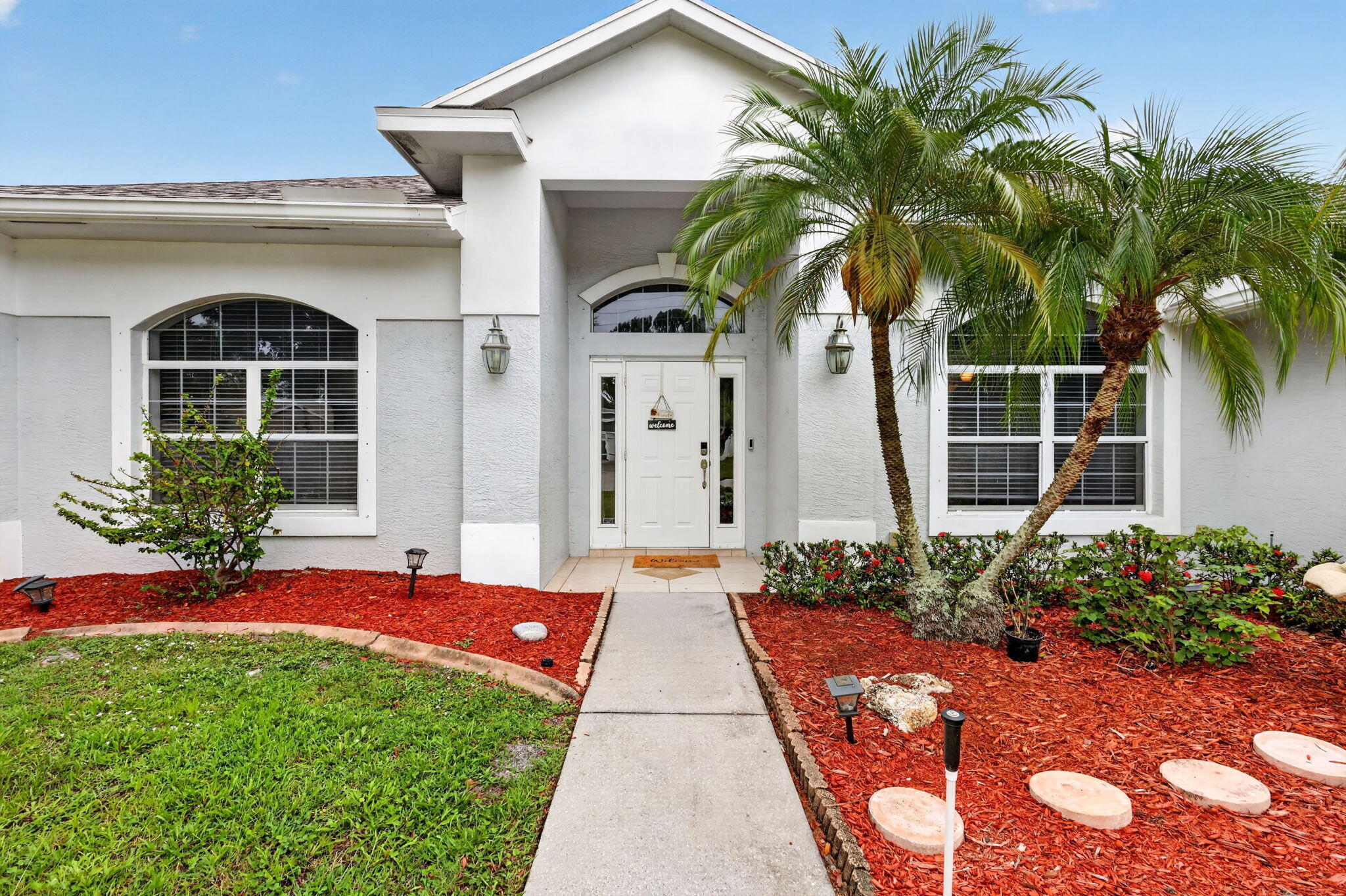 Spacious 3-bedroom, 2-bath CBS home with over 2,000 square feet of living space on a large fenced corner lot with no HOA. Step inside and the open layout greets you immediately - family room straight ahead, flex room to your left, kitchen and bedrooms to your right, with the master suite tucked privately on the opposite side. Soaring 12-foot vaulted ceilings run throughout, making the space feel even larger. The master suite features two walk-in closets and a private bath with a custom tiled walk-in shower. Vinyl plank flooring runs through the home. Kitchen comes fully equipped with all appliances, and the washer and dryer stay. The flex room works perfectly as a fourth bedroom, home office, or TV room. Outside, the fenced corner lot has a wide gate - big enough to pull in a boat, RV, or