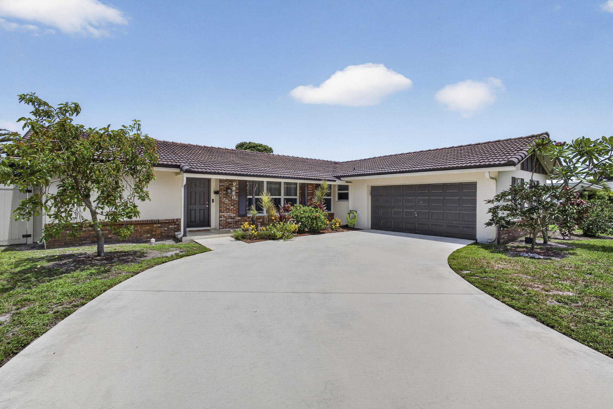 Recently updated 3-bedroom, 2-bath home offering 1,652 square feet of living space in the heart of Palm Beach Gardens with no HOA or restrictions. Major improvements include a remodeled kitchen with newer appliances (approximately 2023), impact windows and doors for added storm protection and peace of mind, and a complete electrical rewire with recessed lighting. Fresh interior paint and a newly painted garage floor add to the home's move-in-ready appeal.  Enjoy the screened-in porch overlooking a fully fenced backyard with mature mango and starfruit trees, creating a private outdoor space to relax or entertain. Ideally located just minutes from I-95, shopping, dining, parks, golf courses, and beautiful beaches, this home offers the perfect blend of comfort, convenience, and rec