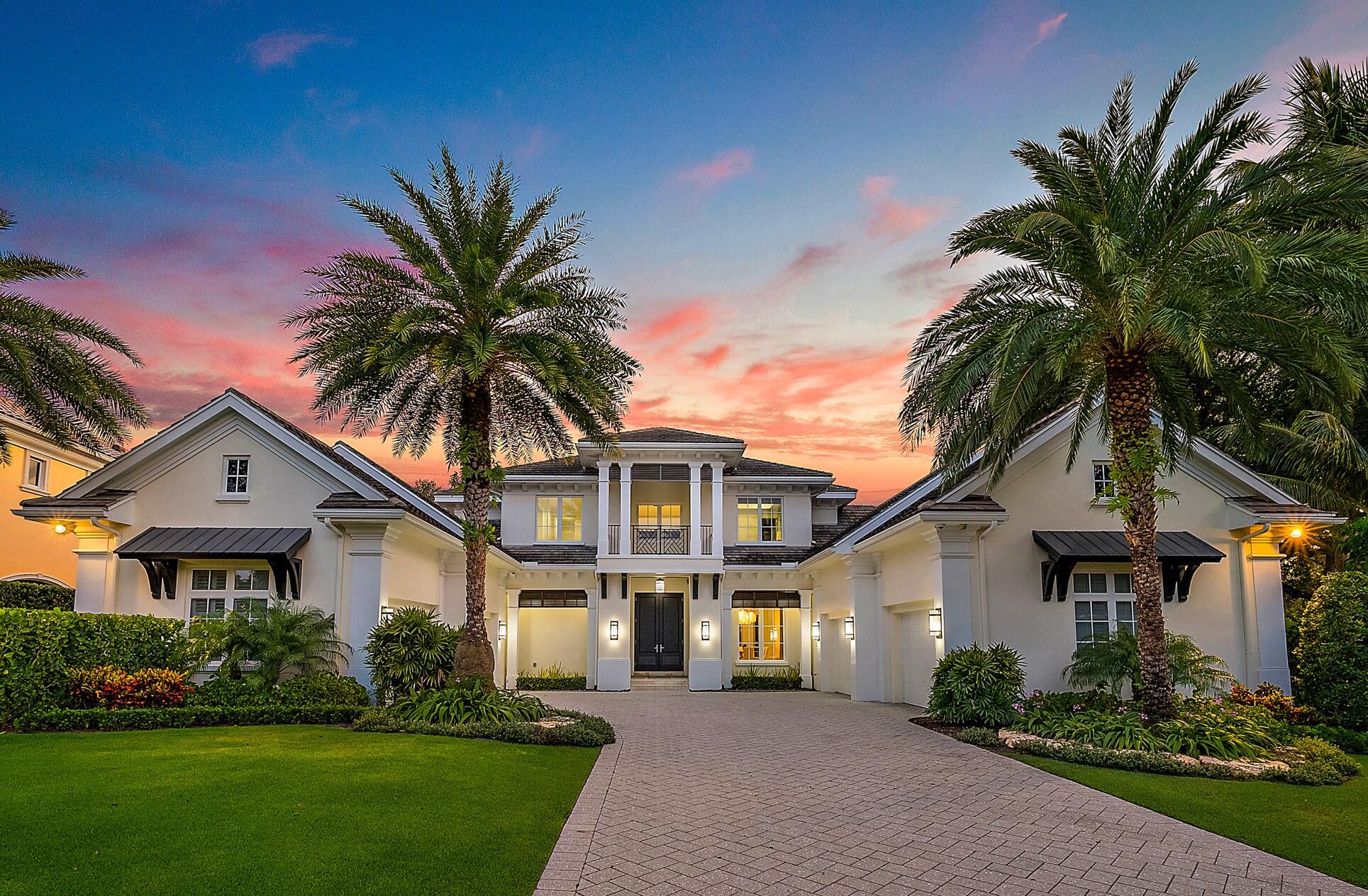CUSTOM RESIDENCE sits on a large half-acre plus lot boasting 132' of wide Intracoastal waterfrontage, with old growth trees and new landscaping, ideal for the outdoor Florida lifestyle. Enjoy the new patio and pool w/ spa, and the all-new covered summer kitchen and grille while watching the big event on the flat screen TV. The lush green lawn slopes down to the private dock and 20,000 lb. boat lift. All this outdoor beauty is enjoyed from the first floor Primary bedroom, office, living room, and  kitchen/family room with casual breakfast area.  The home also includes a wine room, dining room, a guest bedroom that can double as a second office, laundry, dual garages for four vehicles with ample room for storage, and a large bonus room. The second-floor features three en-suite bedrooms, a media room, built-in bar area, each complimented by the views offered by an oversized balcony perfect for taking in the sunset. Smart home with the latest Crestron lighting, sound, and security system. New pool equipment. 48 KW whole house generator.  List of features and improvements available.