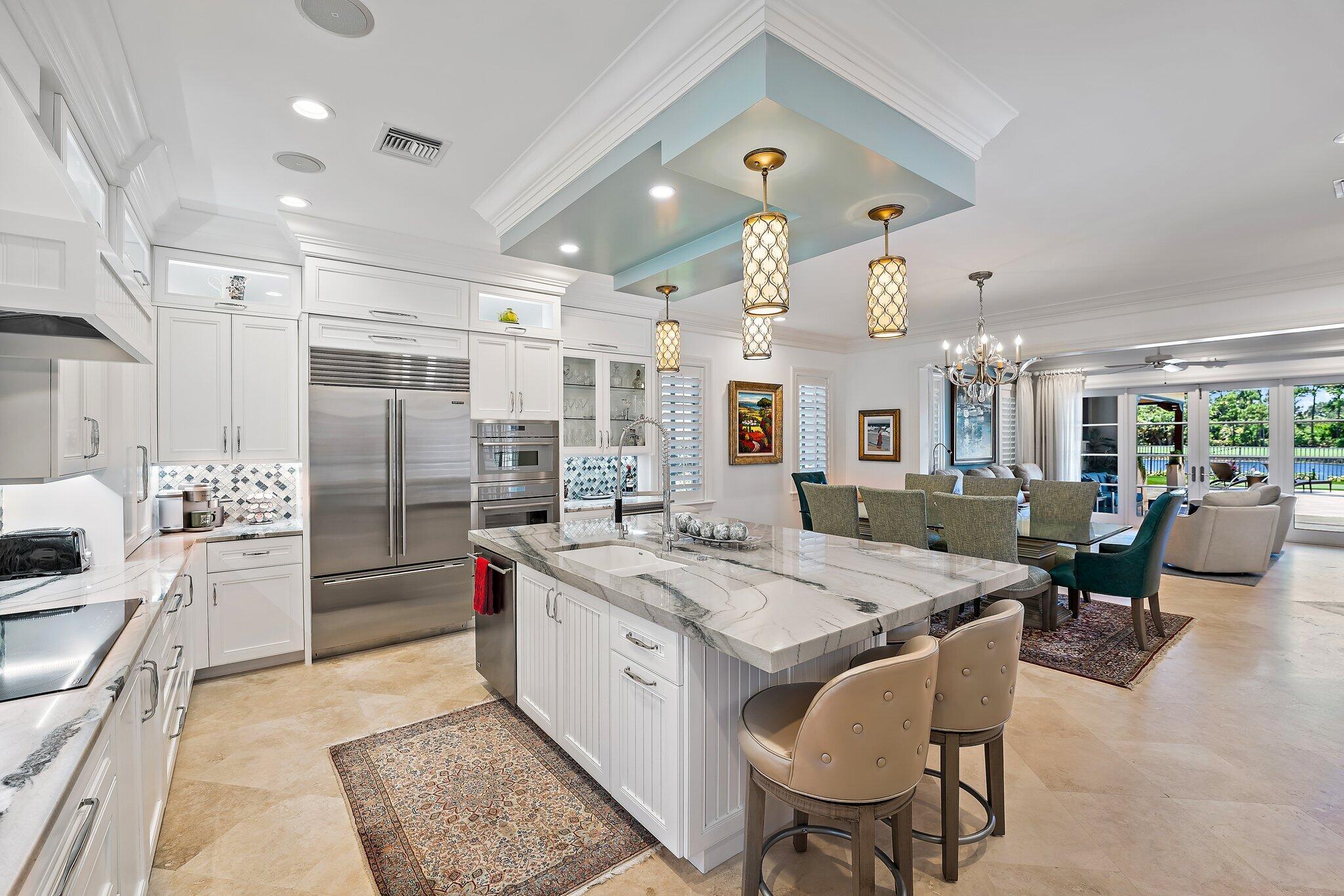 This amazing home sits on one of the finest lots in Trump National - Jupiter.  Enjoy wonderful outdoor spaces overlooking a large lake and the 3rd hole of the Jack Nicklaus signature golf course, while entertaining friends and family.  Electric screens provide the perfect space to open doors to the family room, and relax in the fresh air.  The master suite, including an expanded area for a home office, and one other bedroom occupy the first floor, while two guest suites make up the second floor.  The kitchen, dining area, family room, and living room have been totally renovated with a warm palette of coastal colors.  Both Full Golf and Social/Spa memberships to the club are available, but not mandatory.