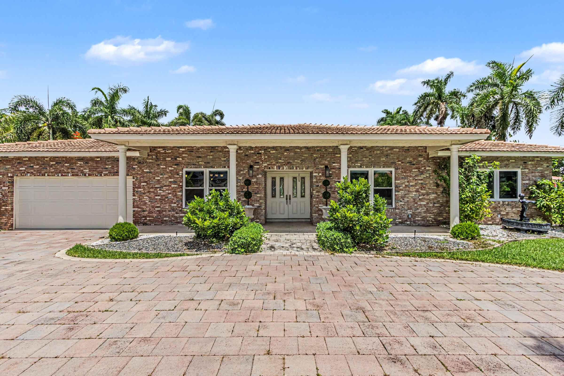 Welcome to this stunning ranch-style pool home in the prestigious "Saddle Club Estates" section of Bonaventure. Nestled on an estate-sized waterfront lot just shy of an acre, this 4BR/3BA property offers ultimate privacy with mature palms lining the grounds. A paved block circular driveway leads to a 2-car garage, welcoming you inside to a beautifully upgraded Mediterranean-style kitchen. Equipped with premium SS KitchenAid appliances and a center island, the large breakfast area opens seamlessly into a spacious family room with covered patio access—perfect for indoor-outdoor living & entertaining. With nearly 43,567 SF of land, there is immense potential to expand or build a separate mother-in-law suite. This home & property is perfect for a large & growing family - Excellent for entertaining, perfect lot for expansion.  Low HOA Annual Fee $500. Also,  exclusive for Bonaventure residents is membership to the Bonaventure Town Center Club, a 70,000 sf recreation facility. With 2 pools, tennis, pickleball, fitness center, classes and more, the opportunity for an active lifestyle is endless. Annual fee per household is $420.