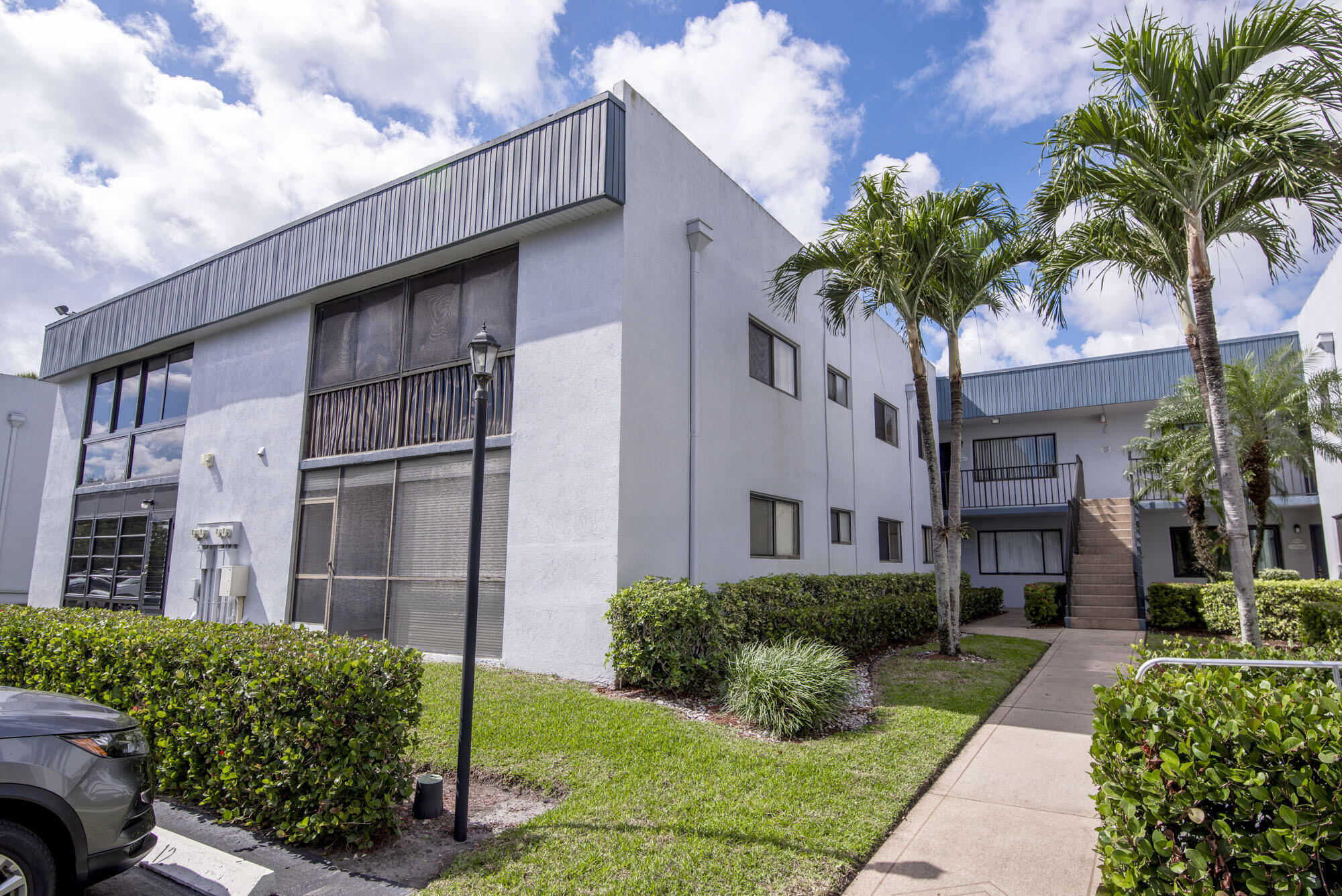 Annual Rental Only! This light and bright condo features 2 bedrooms and 2 bathrooms, each with walk-in closets. The primary bathroom includes a shower stall, while the second bathroom offers a full bathtub. Sliding glass doors lead out to a spacious balcony--perfect for enjoying your morning tea. The unit includes an in-condo washer and dryer for your convenience and is available furnished or unfurnished. The elevator is conveniently located right in front of the unit. Situated directly across from the clubhouse and main entrance, this well-maintained, manned-gate community offers fantastic amenities. Enjoy access to the clubhouse, which hosts a variety of activities and social clubs, as well as pickleball and tennis courts, and a car wash with a vacuum station. Located just off Atlantic.