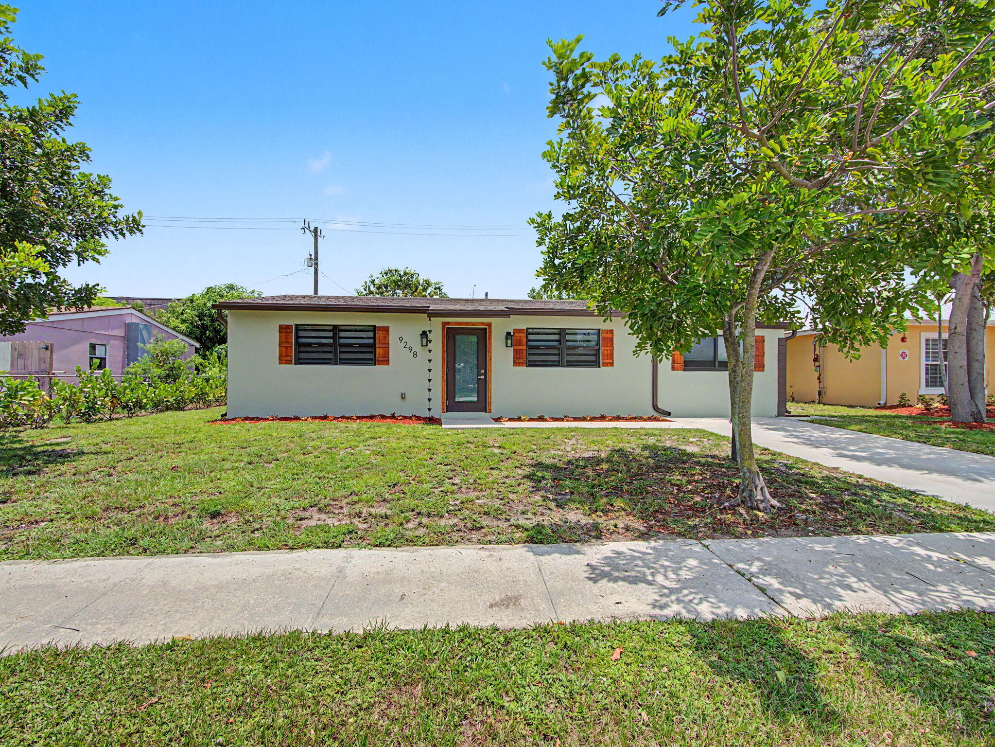 Fully renovated 3 bedroom, 2 bath home in Palm Beach Gardens with permitted improvements throughout. This move-in ready property features a new roof, all-new electrical wiring with upgraded 150-amp panel, new Trane central A/C with Google Nest thermostat, all-new ductwork, and new luxury vinyl flooring. The prior cast iron plumbing has been replaced with PVC and new copper supply piping.  Enjoy new impact windows and doors, fresh interior and exterior paint, new gutters, and a new concrete driveway. The updated kitchen offers quartz countertops, shaker-style cabinetry, and new stainless steel LG smart Wi-Fi appliances. Additional features include custom window treatments, a split floor plan,  and a primary suite with en-suite bath plus an attached full laundry room with full-size LG TurboWash appliances and folding space. The spacious backyard offers room for a pool and/or screened patio, plus a mature mango tree that produces fruit. Conveniently located near I-95, Florida's Turnpike, PBI Airport, shopping, dining, beaches, and top-rated schools. No HOA fees.