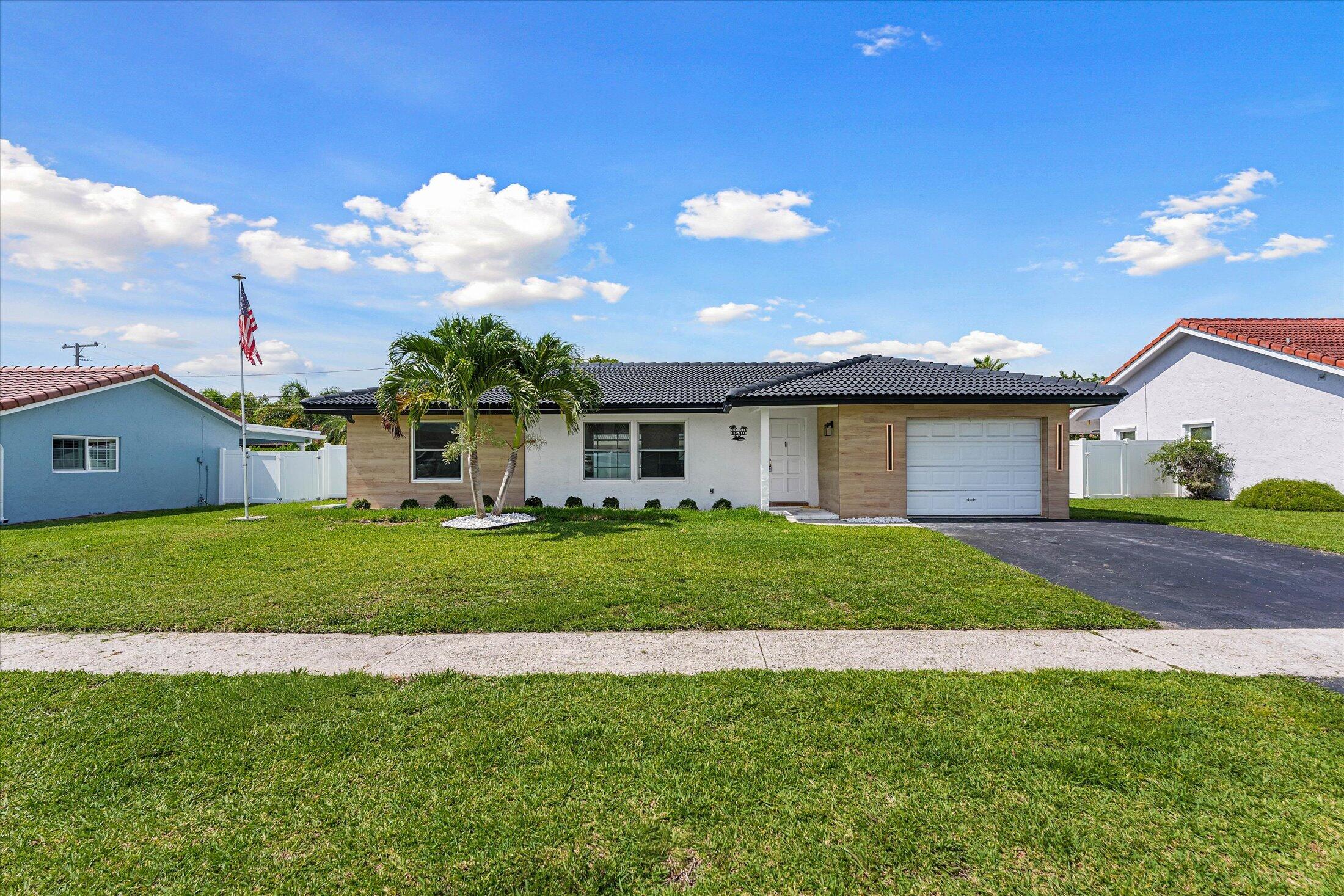 Welcome to 1540 NW 10th Street, a beautifully renovated 3-bedroom, 2-bathroom pool home in the highly desirable Country Club Village community in East Boca Raton.   Completely remodeled from top to bottom, this immaculate residence feels like a brand-new home and has never been lived in since the renovation.  Step inside to discover a bright, open floor plan featuring luxury new flooring throughout, a stunning designer kitchen with modern cabinetry, quartz countertops, and stainless steel appliances including a beverage fridge, as well as beautifully renovated bathrooms with contemporary finishes. Impact glass sliders provide abundant natural light while offering peace of mind and energy efficiency.   The outdoor living space is equally impressive, featuring a newly resurfaced heated pool, expansive travertine patio, and screened enclosure—perfect for year-round enjoyment, entertaining, or simply relaxing in your private backyard oasis.  Additional features include a one-car garage, with sink and a new washer and dryer, ample driveway parking, and meticulous attention to detail throughout.  Ideally located in East Boca Raton, Country Club Village offers convenient access to Boca Raton's best amenities, including top-rated public schools such as Boca Raton High School, Boca Raton Middle School, and JC Elementary. Just minutes from I-95, beautiful beaches, Mizner Park, Town Center Mall, fine dining, shopping, parks, golf courses, and downtown Boca Raton.  Move-in ready and available for immediate occupancy. Rarely does a rental of this quality become available. Make this exceptional East Boca pool home yours today