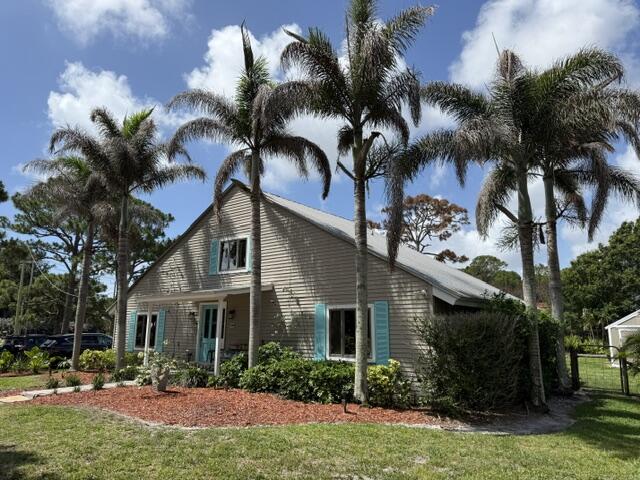 Charming Swiss Chalet on large corner lot in desirable Indian River Estates. Large bedroom suite on 2nd floor and smaller suite on first floor. Spacious living room and dining area with wood burning fireplace, Vaulted cedar ceiling. Kitchen updated with solid wood cabinets, Cambria quartz countertop, Stainless steel appliances and newer ice maker.  Large pantry with stacked washer and dryer. Beautiful bright Laminate flooring throughout home. Bathrooms updated. Solid wood door and window frames. Enchanting back porch and back yard, yard is fenced except a small area. Wood working shop 16x20 with new roof, electric and small a/c unit.  There is a park with small lake and children's play area and bike path nearby. Beaches, boat ramps, lagoon and shopping nearby All measurements and data taken from property Appraisers office
