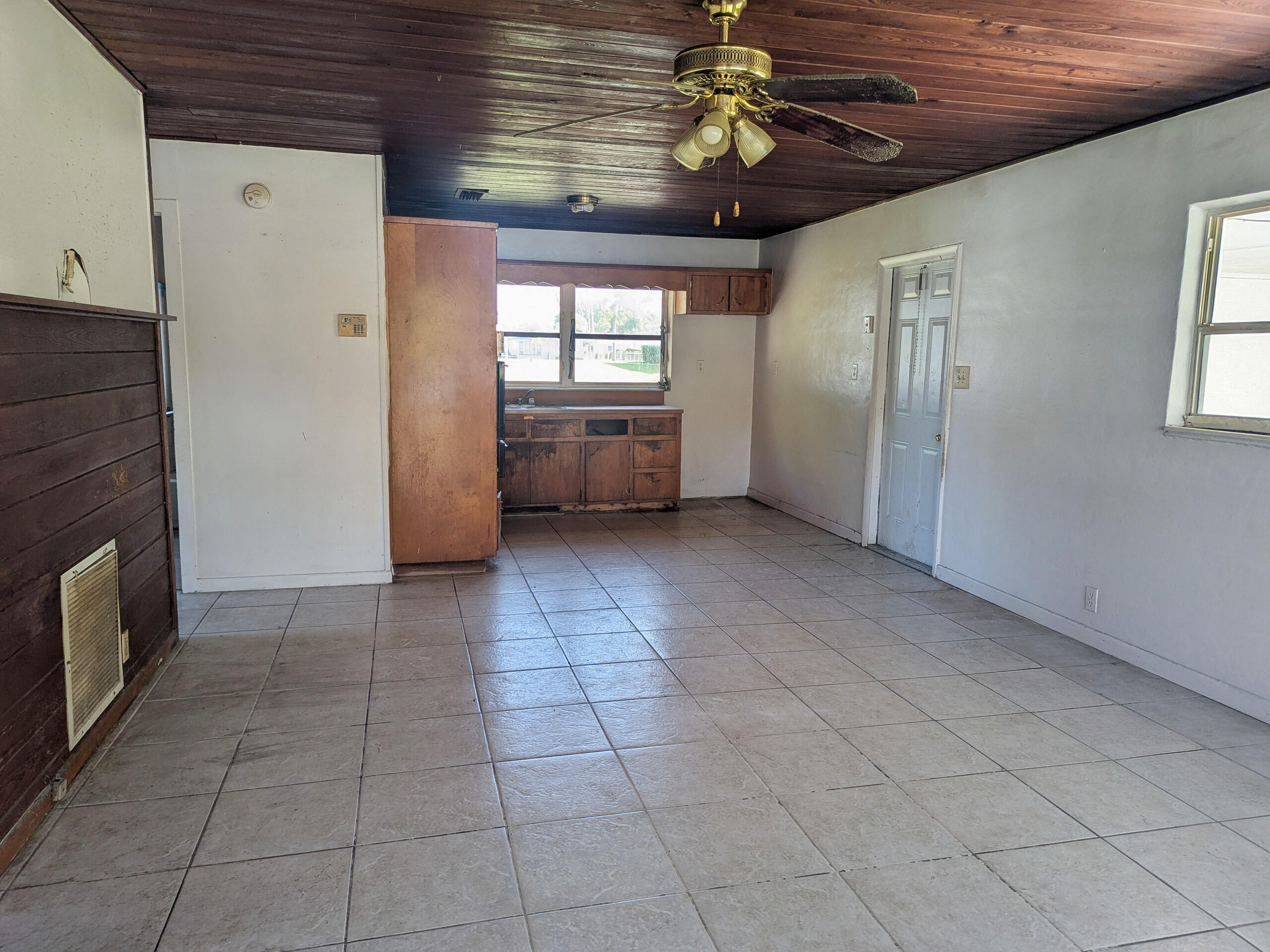CBS 2 bedroom 1 bath plus utility room with 1/2 bath is ready for your vision. Home has terrazzo & tile floors and real wood vintage kitchen cabinets.  Located close to downtown, airport, beaches, shops and more. This is a Fannie Mae HECM HomePath property.