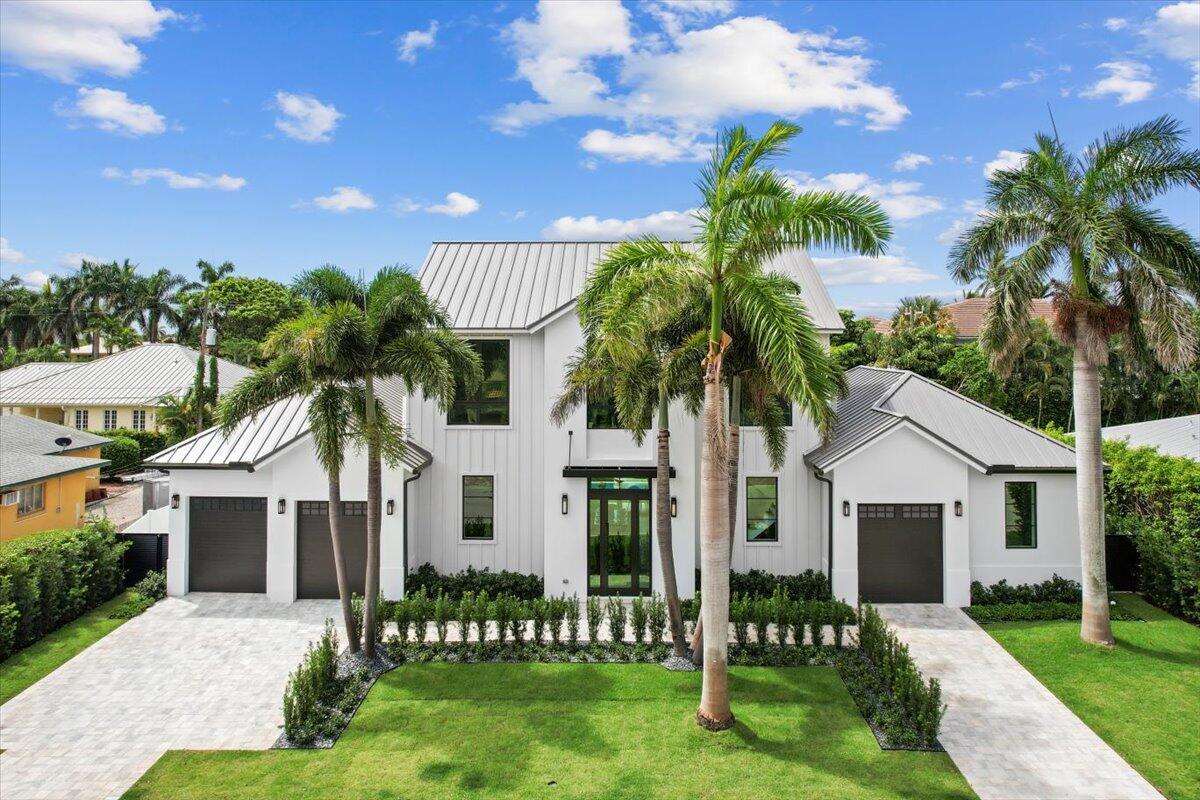 Welcome to 224 Edmor, the newest creative space designed and built by the Award winning team of Borrero Architecture and Sam Fisch Development. This take on the Modern Farmhouse mixes contemporary architecture with ultra luxury finishes on one of the best streets in the trendy SoSo neighborhood along West Palm Beach's South Flagler Drive. Boasting over 5000 sq feet of living space with 5 bedrooms and 4 ½ baths over two floors, this home has been meticulously designed to take advantage of its wide lot with a three car garage- perfect for car enthusiasts or fitness oriented families. The open concept floor plan displays a custom built kitchen equipped with Wolfe range, two Bosch dishwashers and paneled Sub-Zero fridge/freezer as well as a full size wine cooler for entertaining.