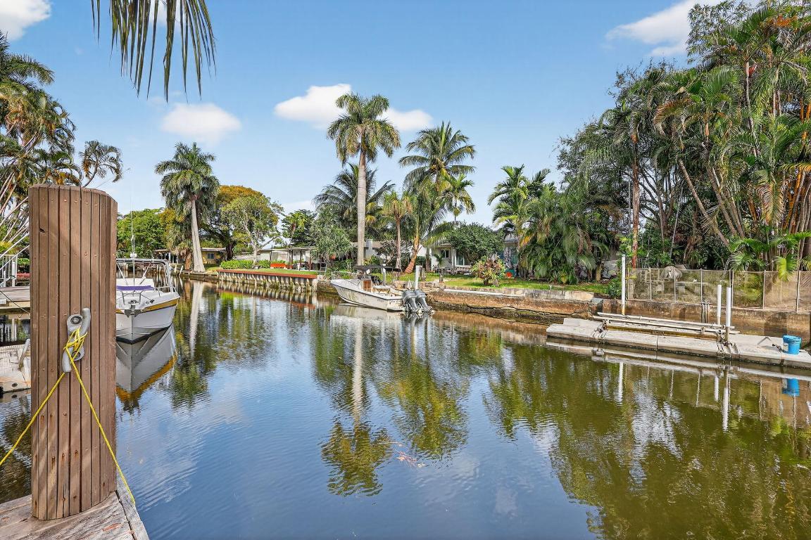 Beautiful and bright ranch home with newer roof replaced in 2025, impact windows/doors, and  stunning canal views from the expansive backyard, featuring a private pool with gorgeous deck, large storage shed, abundant green space and impressive dockage— over 60 feet on one side and over 20 feet on the other along with 30 amp shore power. Ideal for boat enthusiasts.  The home boasts travertine marble floors, granite kitchen counter, upgraded bathrooms, jacuzzi tub, large bedrooms, and a beautiful Florida room.  Airbnb-friendly with no HOA, making this an excellent opportunity for short-term rental or income-producing use. Prime location just minutes from the beach, Hollywood International Airport, and the world-famous Hard Rock Seminole Casino. A must see!