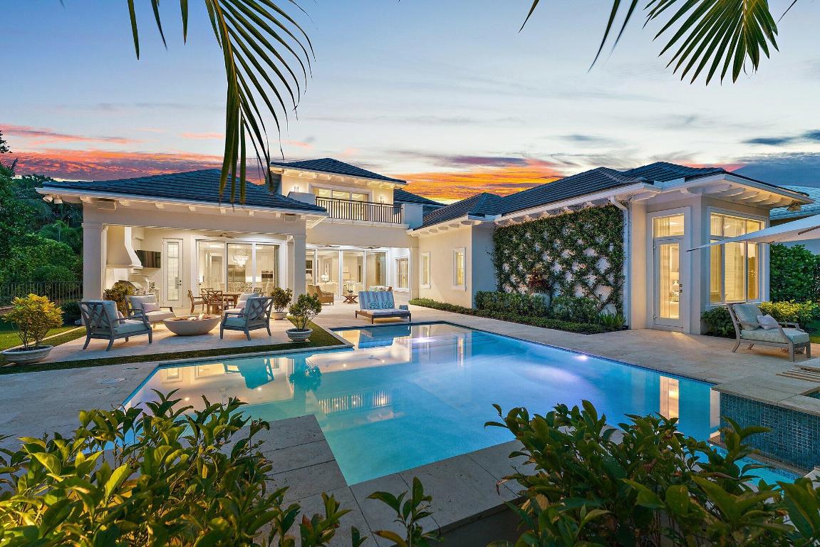 This signature property has one of the finest views in all of Old Palm Golf Club.  Casual elegance abounds from this British West Indies estate, recently renovated and redecorated in 2022.  A two-story residence, it boasts the following features on the main floor:  Primary Suite with separate his/hers bathrooms and closets; an oversized den/club room with built-ins; one guest suite; a large great room; breakfast room; kitchen with double islands, Cristallo Quartz countertops, and Wolf/Sub Zero/Bosch appliances; formal dining room; laundry room; elevator; formal powder room; cabana bath; and three car, plus golf cart, garage spaces.. The second level has a large loft area with balcony that overlooks the pool and view to the 11th green and 12th fairway on the Raymond Floyd championship golf course and one of the largest lakes in the community, plus two additional guest suites.  Exterior features include: a circular driveway; lush landscaping; covered loggia spaces in the rear yard with electric screens; summer kitchen with Lynx Grill and pizza oven; gas fire pit with seating area; additional patio lounging areas, spa and lawn area - all with amazing views to golf and water.  Additional special touches include a Savant Home Automation & Lighting Control System; whole house water filtration system; and new pool equipment.  The clubhouse at Old Palm was recently renovated, and a 20,000 SF Lifestyle Center was newly constructed with a fitness center and spa that is the envy of every club in the area.  Golf enthusiast will love the 33- acre practice facility with three full length golf holes, an expansive driving range, putting and chipping areas, and a golf studio with the latest video technology for instruction.  This bespoke estate truly has it all - and it could be yours!