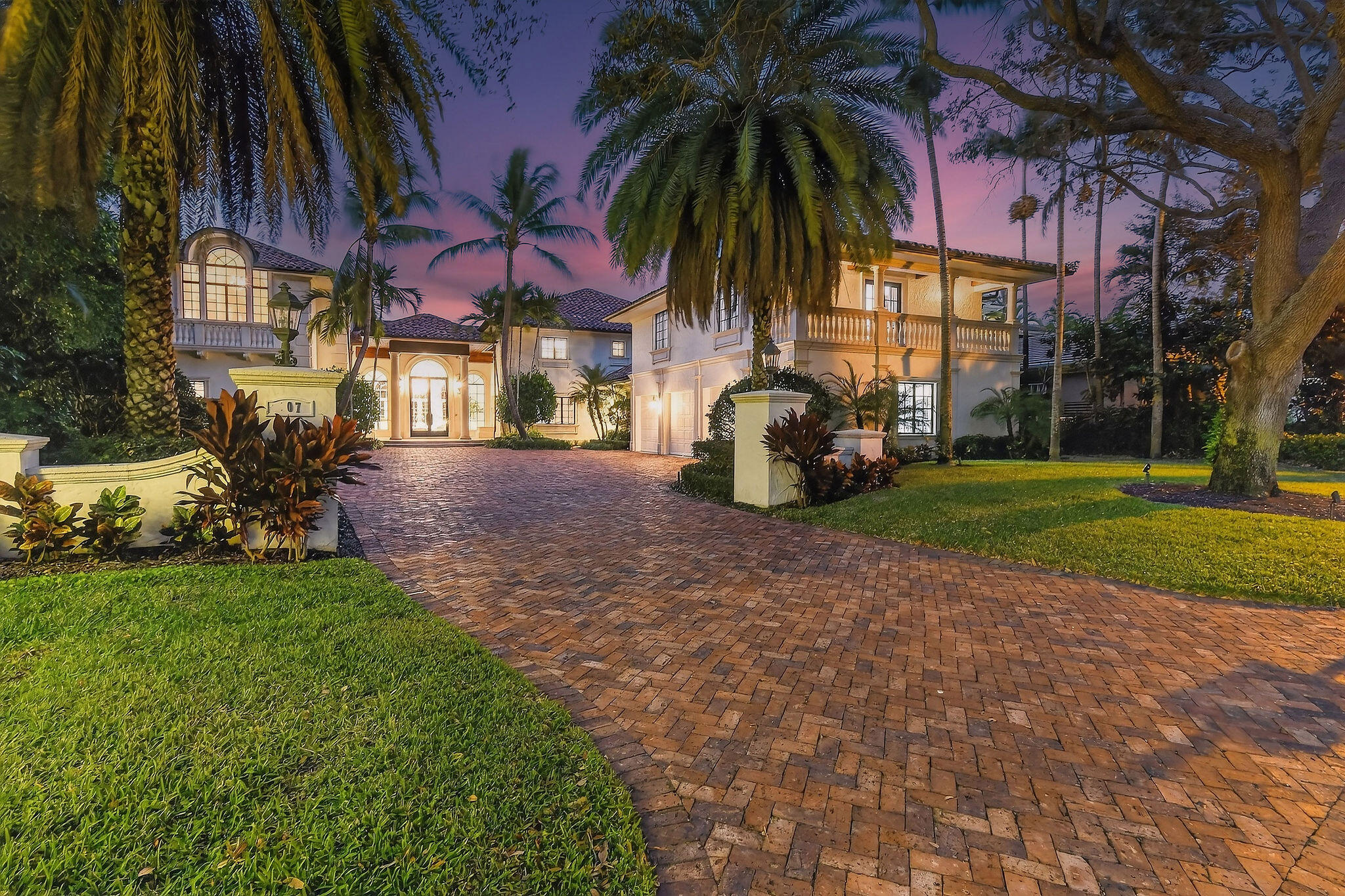 Set on a coveted cul-de-sac in the heart of Admirals Cove, 107 Schooner Lane is a rare waterfront and golf course estate offering extraordinary scale, privacy, and craftsmanship. Built by the renowned Turtle Construction and recently enhanced with major new renovations, this impressive residence encompasses approximately 11,200 square feet under air, on an expansive half-acre homesite. A grand arrival sets the tone, with a stately entrance, full-house generator, and commanding presence. Perfectly positioned, the home enjoys serene water inlet views on one side and sweeping golf course vistas on the other—without sightlines to neighboring homes or garages, creating a sense of complete seclusion. The interiors are both expansive and refined, featuring seven generously sized bedrooms, including two primary suites and a junior suite, complemented by eight full bathrooms, a half bath, and an additional powder room. Two private libraries, dual elevators, including a dedicated elevator serving the primary suite, and multiple gathering spaces enhance both comfort and functionality. Designed for elevated living and entertaining, the home offers two oversized family rooms, upstairs and down, two full bars for indoor and outdoor enjoyment, and a stunning wine room. Dual chef's kitchens anchor the home, each featuring 10-foot islands and a total of four refrigerators, ideal for hosting on any scale. A whole-house water purification system ensures uncompromising quality throughout. The estate is offered fully furnished with all-new, modern contemporary furnishings curated by a top decorator and sourced from a premier furniture house. Additional highlights include a state-of-the-art gym and media room, a completely renovated garage with custom his-and-her cabinetry, and seamless indoor-outdoor living. Outdoors, a private dock with two slips provides direct water access, while the home's superior location places the Admirals Cove clubhouse just a short walk away and A1A only minutes by car. The property includes a full golf membership, completing a truly turnkey offering in one of Jupiter's most prestigious communities. This is luxury living at its finest, where scale, quality, and location converge.
