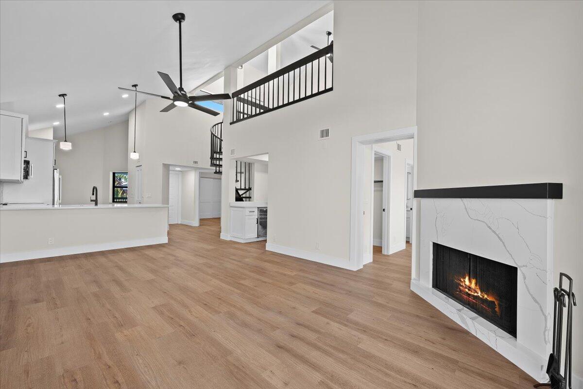 Welcome to Bay Colony, a premier intracoastal community in the heart of Juno Beach, where coastal living meets resort-style luxury. This 4th-floor penthouse has been completely renovated from top to bottom, offering a truly turnkey opportunity with high-end finishes throughout—no projects, no punch lists, just move in and enjoy.

The residence features soaring 24-foot ceilings, a wood-burning fireplace, and a loft-style third bedroom that adds architectural interest and flexible living space. The brand-new interior includes new flooring, doors, trim work, raised ceilings, hurricane-impact windows, designer lighting fixtures, and fully remodeled bathrooms with modern vanities. The quartz kitchen is outfitted with custom cabinetry and stainless-steel appliances. Step outside to a large private balcony overlooking the resort-style pool and lush tropical gardensthe ideal backdrop for morning coffee, evening cocktails, or quietly reminding yourself that this is, in fact, your life now.

Bay Colony offers an exceptional lifestyle with private marina access (boat slips available for purchase or lease), resort-style pool and hot tub, pickleball and tennis courts, bocce ball, fitness and business centers, outdoor grilling stations, and kayak storageeverything you need to fully embrace coastal living. The community is financially sound with no upcoming assessments, a rare and valuable bonus.

Ideally located just minutes from Juno Beach, top-tier shopping, dining, and local attractions, this penthouse delivers the perfect blend of luxury, location, and lifestyle. Renovated. Elevated. Ready to impress.
