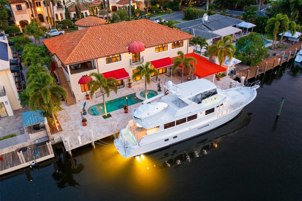 Custom Built Home on Desirable Seminole Drive.110 ft Sailboat Draft Frontage | Turning Basin on Quiet Waters | 300 AMP Dock Service.Living: Crema Marfil Floors. Wet Bar: 80 Bottle Wine Cooler | Copper Hood | Illuminating Agate Gemstone Top. Home Theatre: Soundproofed & Stadium Seating. Kitchen: Gas Wolf Range | Custom Lighted Cabinetry | Copper Hood. Staircase Tower: Suspended Wrought-Iron & Marble Staircase | Stack Stone Curved Walls | 6-Ft Crystal Chandelier | Faux Painted Ceiling.Master Suite: Covered Terrace with Wet Bar | Large Closet with Rows of Built-Ins & Onyx Tops. Master Bath: Onyx Tops | Two Water Closets | Bidets | Glass Shower | Spa Tub.Patio: Covered in Travertine | Summer Kitchen | Fireplace.Salt Water Pool: Heated with Spa. Outdoor Cabana Bath | Natural Gas. 4 car air conditioned garages 100 psi air compressor 3000 psi pressure washer Doctor Aroma scent throughout home and garages 16 cameras on the property Copper guttersSonos sound system indoors and outdoorsWater softener & carbon filterTwo on demand hot water heatersDedicated natural gas line from Sunrise Blvd(6) Trane Air Conditioning  units Mitsubishi mini split air conditioning system for work out room 600 amp service (300 amps dock) (300 amps home) Travertine pavers outside and travertine tile in the garagesArtificial turf and fruit trees Saltwater pool with separate heating and cooling pumpHot tub with dedicated natural gas furnace Concrete yard & dock, covered with travertine tile(2) Automated 12-foot-wide sun-setter type awnings 3 dock pedestals, each pedestal equipped with 100 amp service20”X 35” shaded area (canvas awning) Wood burning fireplace with natural gas starterLynx gas grill with rotisserie and Kholer sink 3 refrigerator drawers and icemaker  5 Natural gas tiki torches (cast iron) 2 outdoor showersAutomated irrigation system on propertyINTERIOR FEATURES: 8 foot diameter crystal chandelier with 88 LED light bulbs mounted on cable lift for easy maintenance Electric Hunter Douglas shades throughout homeMarble floors, grout lines filled with epoxy to create seamless surfaceElevator BAR: Countertops made of Agate Slice Stone from Italy completely underlit with LED panels2 Subzero refrigerator drawers Wine cooler for 82 bottles Ice maker Edgar Berebi custom drawer hardware All drawers are deep enough for half gallon bottlesCopper bar hood Work Out Room:Yoga matt foam flooring Waterview and 2 TV’sKitchen: Wolf 4 burner gas stove with 24 inch griddle in the middle Wolf double oven + warming drawer Countertop Steamer with automatic drain systemSubzero 48” wide refrigerator + 36” wide freezer2 dishwashersMiele coffee makerMiele microwave convection Maple wood cabinets with automated LED inside lightsBedroom 1, ground floor French doors to the outside  All glass shower doors are ½ inch thick, special ultra clear glass2nd Floor: Breakfast bar: Miele coffee machine 2 Subzero refrigerator & freezer drawerGarbage disposal ultra quiet with indicator light Bedroom 2 (next to the elevator) Tommy Bahama inspired:Safe in the closet Attic entrance for access to chandelier’s cable winchBedroom 3, Hollywood inspired Safe in the closet Bedroom 4, Beach inspired Onyx sink countertop lit from underneathSafe in the closet Master Suite:Romeo & Juliette balcony Large, relaxing waterview terrace equipped with Subzero refrigerator,  freezer, wine cooler, burnt leather countertops, sink and outdoor stair access. Master closet:  Dolce chandeliersMotion sensor lights Washer and dryer & large utility sink Built in safe in cabinetMaster Bathroom:Underlit countertops with motion sensor Tub gets filled up from the ceilingElectric Hunter Douglas blinds His & Hers water closet Water heaters under the sinksSOLID 4-HINGE DOORS ALL THROUGHOUT THE HOUSE