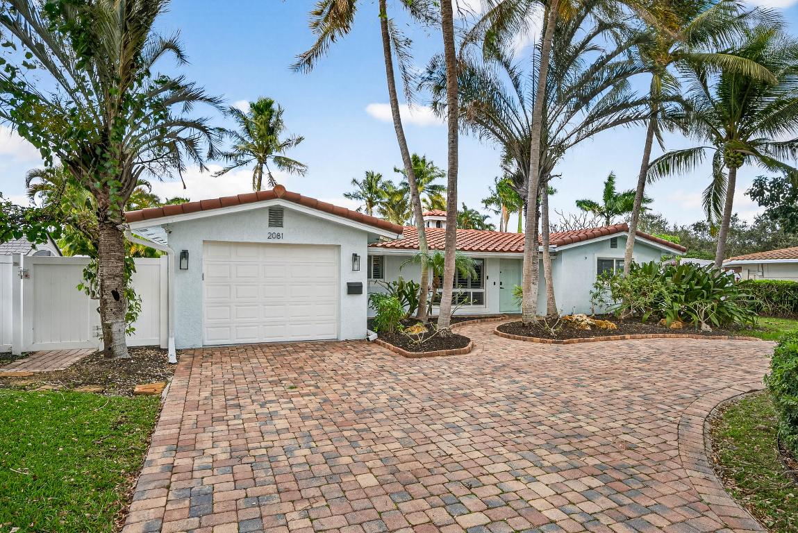 Located in the heart of Lighthouse Point, this beautifully updated coastal home offers the ideal South Florida lifestyle. Featuring a 2023 roof, full impact windows and doors, and Brazilian hardwood floors throughout, the home blends style, comfort, and peace of mind. The spacious primary suite includes his and hers walk in closets, while the open, light filled layout is perfect for everyday living and entertaining. Step outside to a private backyard oasis with a pool, covered patio, and outdoor bar, ideal for year round indoor outdoor living. Situated on an exceptionally deep 125 foot lot, one of the largest in Lighthouse Point, this move in ready home offers optional furnishings and is minutes from beaches, dining, boating, and shopping.