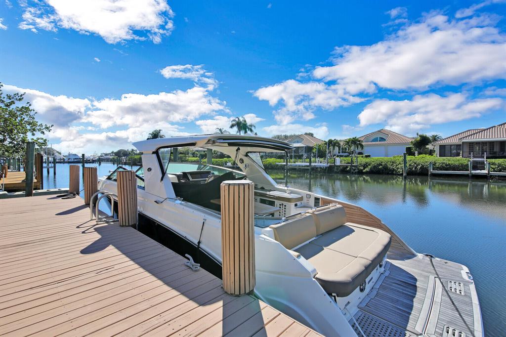 Wonderful waterfront home with 5 BR plus den in desirable Jonathan's Landing.  The deep water dock can accommodate a 58' boat.  The home was remodeled in 2014 extensively.  A new roof was installed in 2018.
