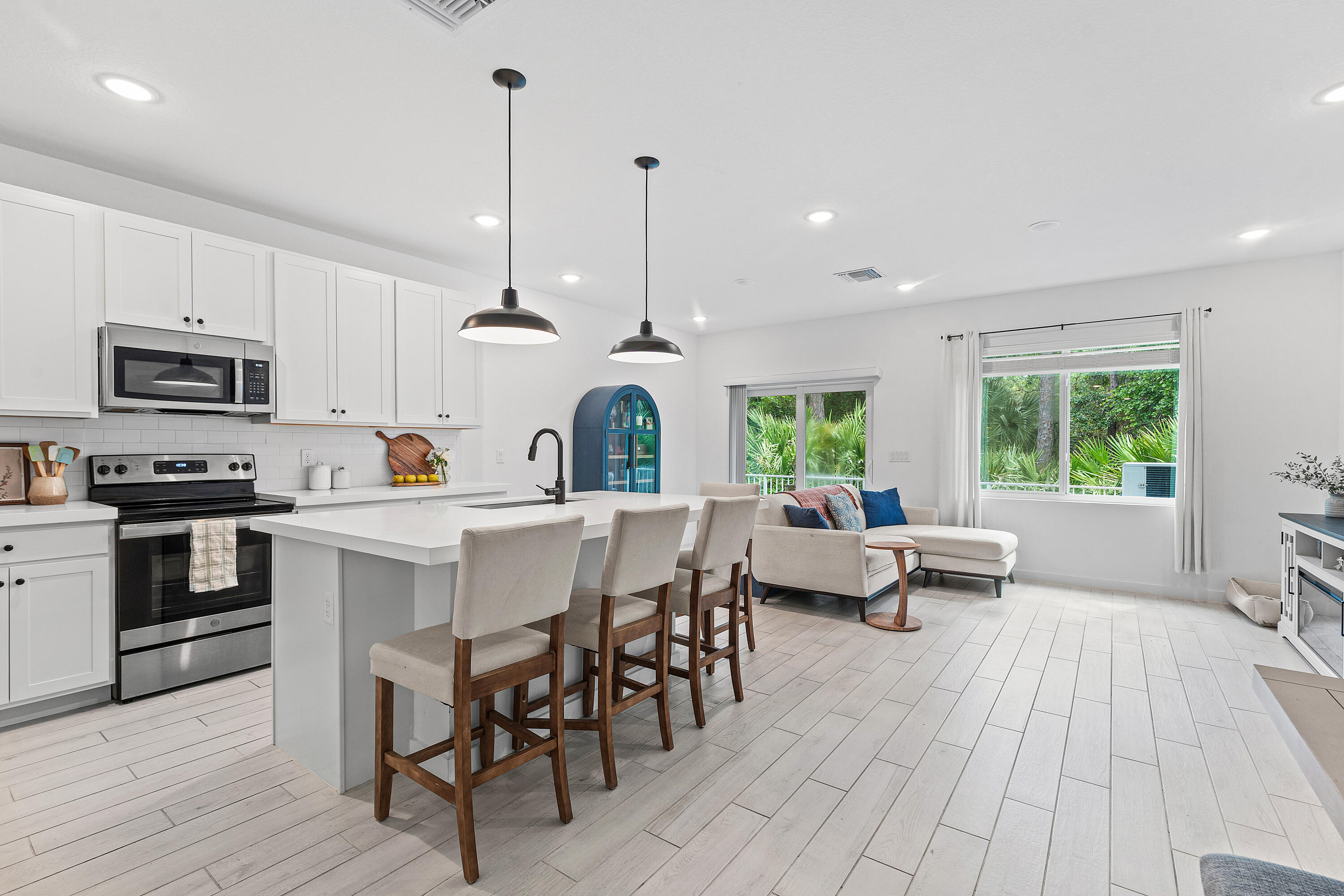 Feels like new construction without the wait. This beautifully maintained 3 bed 2.5 bath townhome offers modern finishes, thoughtful upgrades, and a peaceful preserve backdrop for added privacy. The open living area connects to a kitchen with 42'' white upper cabinets, quartz countertops, and upgraded tile flooring. The primary suite includes a walk in closet and ensuite bath, with two additional bedrooms offering flexibility for guests or a home office. Upgrades include hurricane impact windows, granite bathroom countertops, new vinyl flooring upstairs, and an epoxied garage floor. Community amenities include a pool, sports courts, walking trails, and river access. Close to beaches, parks, and everyday conveniences. Move in ready and easy to show.