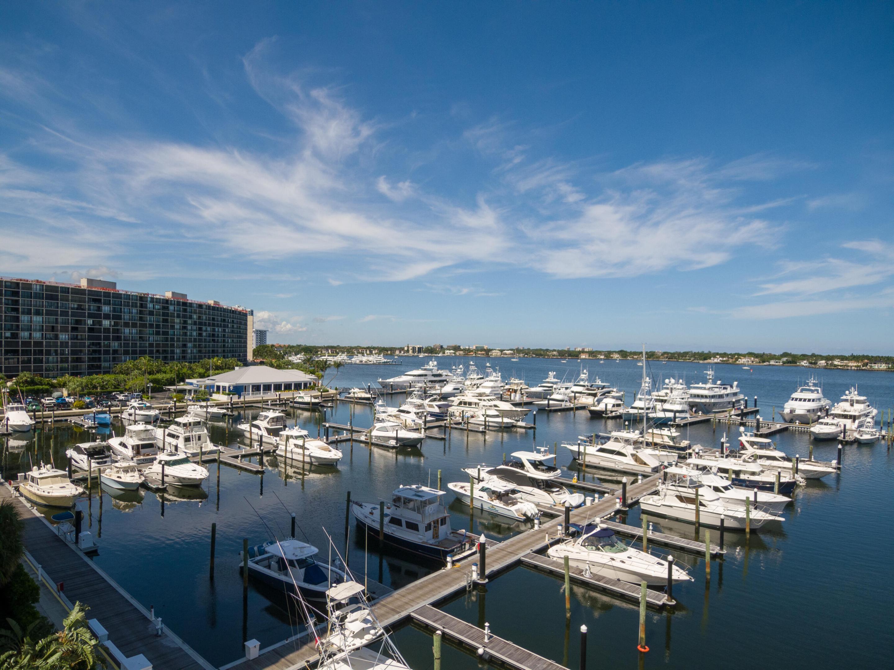 Live the Palm Beach waterfront lifestyle in this fully renovated North Palm Beach corner residence. This stunning 2 Br/ 2-bath condo showcases panoramic ocean & Intracoastal views with a sought-after southeast exposure, filling the home with natural light from sunrise to sunset. Discover  modern coastal elegance with high-end finishes throughout, including sleek porcelain flooring, recessed lighting, and a completely redesigned open-concept layout. The designer kitchen features imported Italian cabinetry, quartz countertops, LG stainless steel appliances, & an oversized island perfect for entertaining, plus a chic built-in bar with wine refrigerator, ideal for hosting & everyday luxury living. The expansive wraparound balcony offers a true indoor-outdoor lifestyle. The spacious primary suite is a serene escape with dual walk in closets and a beautifully updated en suite bath. Additional upgrades includes new impact sliders, and a new electrical panel.  Condo is located in a 24 hour gated community, exceptional amenities include a stylish community room, spectacular waterfront pool overlooking the marina & barbecue area.  This condo is 15 minutes to the beach.