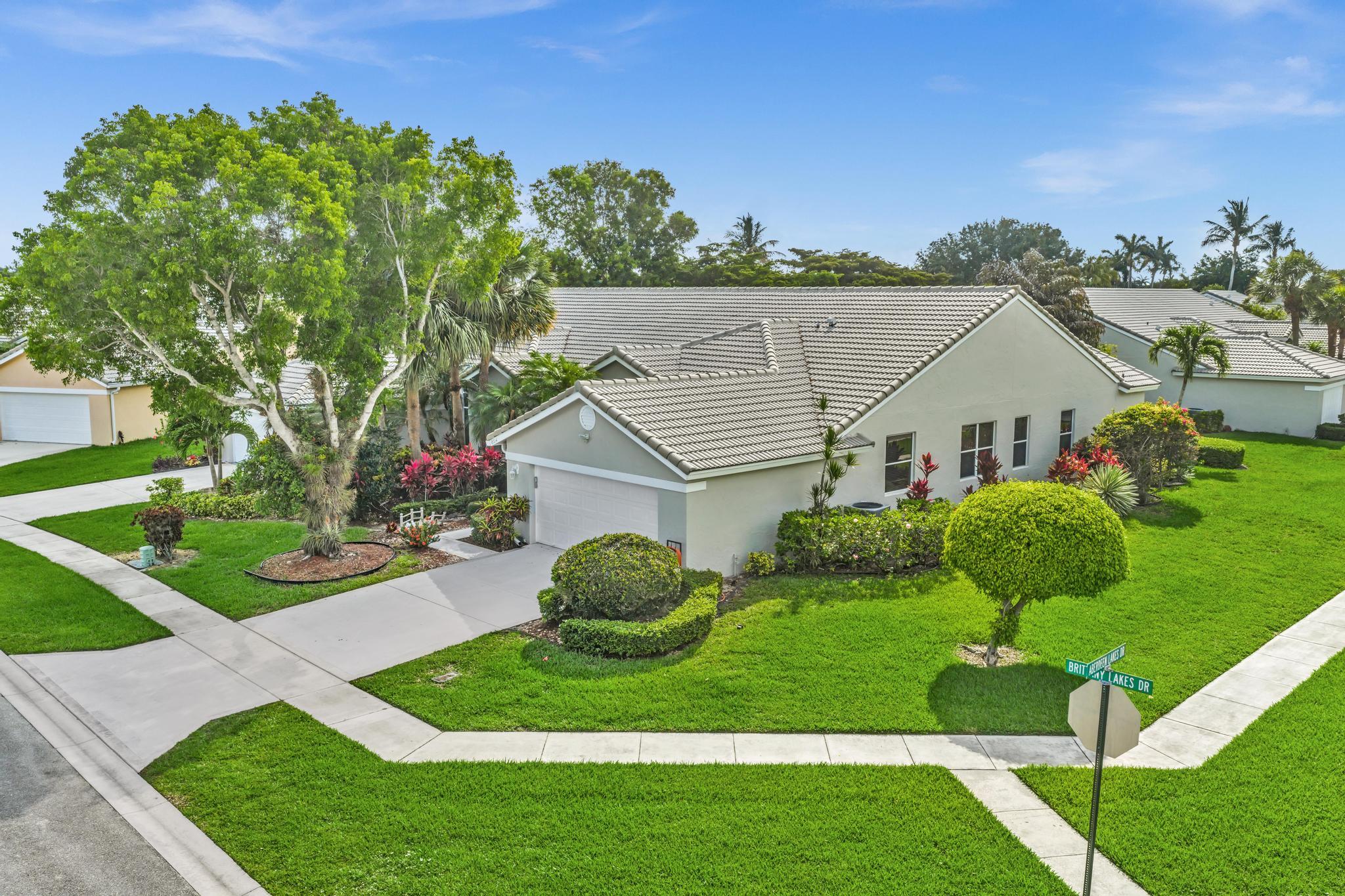 Welcome home to this spacious villa located in the guard-gated 55+ community of Brittany Lakes at Aberdeen Golf & Country Club! This spacious and beautifully maintained true 3-bedroom, 2-bath home offers an open floor plan with volume ceilings and abundant natural light.  Enjoy cooking in the open concept kitchen featuring granite countertops showcasing white cabinetry, a quartz waterfall countertop on the island, and ample pull-out drawers. The living areas boast neutral tile throughout and all bathrooms have been updated.  One of the standout features of this home is the expanded enclosed lanai, seamlessly incorporated into the living space to provide additional square footage and the perfect spot to relax while enjoying peaceful lake views year-round.  Step outside to the private patio—ideal for entertaining or enjoying the Florida lifestyle.  Aberdeen Golf & Country Club offers resort-style amenities with mandatory membership (90.5k buyin and yearly dues), including a Fazio-designed golf course, fitness center, tennis, pickleball, multiple dining venues, and an active social lifestyle. Don't miss this opportunity to own a beautiful home in one of Boynton Beach's premier country club communities!