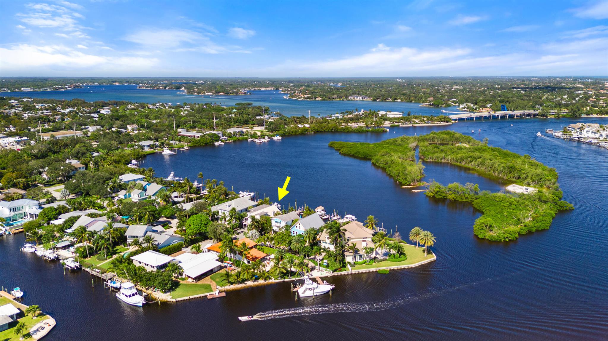 This stunning waterfront home, overlooks the serene waters of Sawfish Island. It is located just minutes from the Jupiter Inlet and with no fixed bridges, this three-story, four-bedroom plus den, three-bathroom residence with 3,516 Sq Ft living space, has been fully remodeled in 2022. The home's expansive open floor plan, with wide plank wood flooring throughout main living areas, is flooded with natural light and provides nearly unobstructed water views from almost every room. The open kitchen boasts quartz countertops, and high-end appliances including a 2022 oven, refrigerator, washer, and dryer, as well as a 2023 dishwasher, 2025 gas cooktop making it ideal for both daily living and entertaining. Recent upgrades also include two new air conditioning units installed in 2023, along with a newer 2023 mini split system in the first-floor entertaining area, ensuring comfort year-round. For added convenience, a new hot water heater was installed in 2024.

Step outside to the waterfront and enjoy the home's beautiful landscaping, featuring low-maintenance AstroTurf that ensures a lush, green look without the upkeep. The home's private boat dock recently redone in 2022 is a standout feature, with space for two vessels-one up to 60 feet and the other with a 16,000 lb lift, making it perfect for boating enthusiasts. The dock and two patio areas, which overlook the water, are ideal for outdoor entertaining, with a built-in bar with beverage refrigerator in the downstairs family room entertainment area that makes hosting a breeze.

Additional features of this home include impact glass windows and doors, a full interior and exterior security system, and a metal roof. The extra garage storage space is perfect for stowing away gear or water toys, while the home's close proximity to the Jupiter Inlet makes it a dream location for boaters and outdoor lovers.

Whether you are relaxing on the waterfront patio, enjoying the spacious family room, or taking in the views from one of the many rooms with water vistas, this home offers the ultimate in luxury waterfront living.

All taxes, measurements and sizes are approximate.