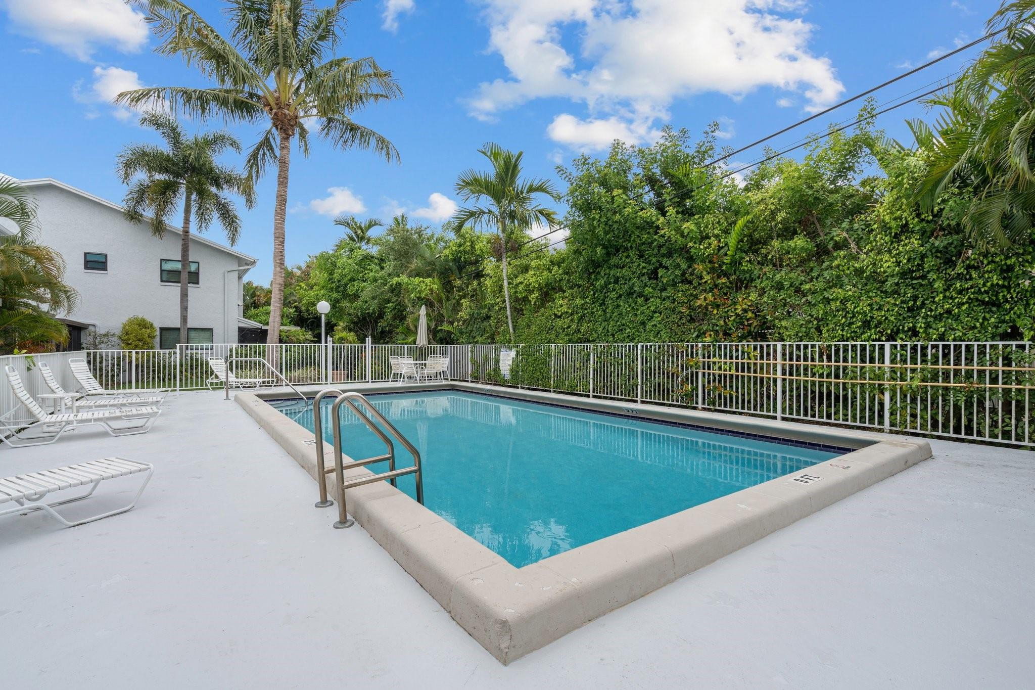 Located on a beautiful tree-lined street is this wonderful 2-BR/2.5BA townhome in desirable Lighthouse Point community, east of US-1. Two spacious ensuite primary bedrooms. Open-concept kitchen, living & dining areas with tiled floors. HURRICANE IMPACT WINDOWS & DOORS THROUGHOUT. Updated kitchen with granite countertops & stainless-steel appliances. SCREENED-IN PATIO WITH LOVELY GARDEN VIEWS & STEPS TO THE POOL. Newer A/C. New roof (2023). Newly painted exterior (2025). Full-size washer/dryer in unit. Under stairs storage. Pet-friendly. Amazing location, close to the beach, shopping & dining. Also, a short ride or walk to Dan Witt Community Park (tennis, pickleball, soccer, baseball, basketball, volleyball, kids play area, picnic areas, covered pavilion & more).