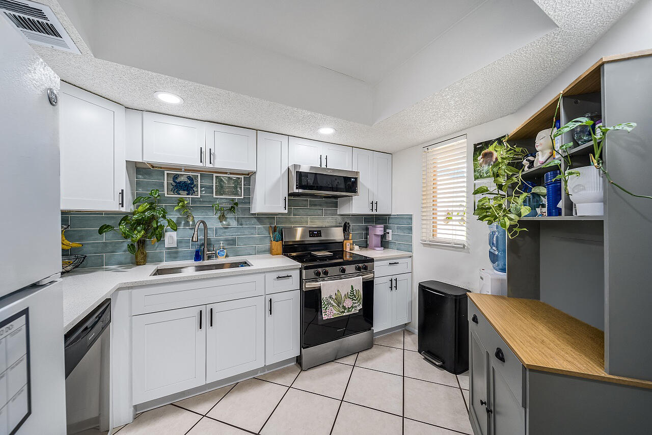 Immediate income potential! Spacious 3 Bed, 2 Bath, first-floor condo in the heart of Port St. Lucie. This tenant-occupied condo offers a rare opportunity for a Buyer to take over the existing lease and be grandfathered in without waiting the typical one-year leasing period. Features include a low HOA fee, in-unit washer & dryer, updated kitchen with quartz countertops and a convenient location near medical offices, shopping, restaurants and more. A great opportunity for investors or buyers looking for built-in rental income!