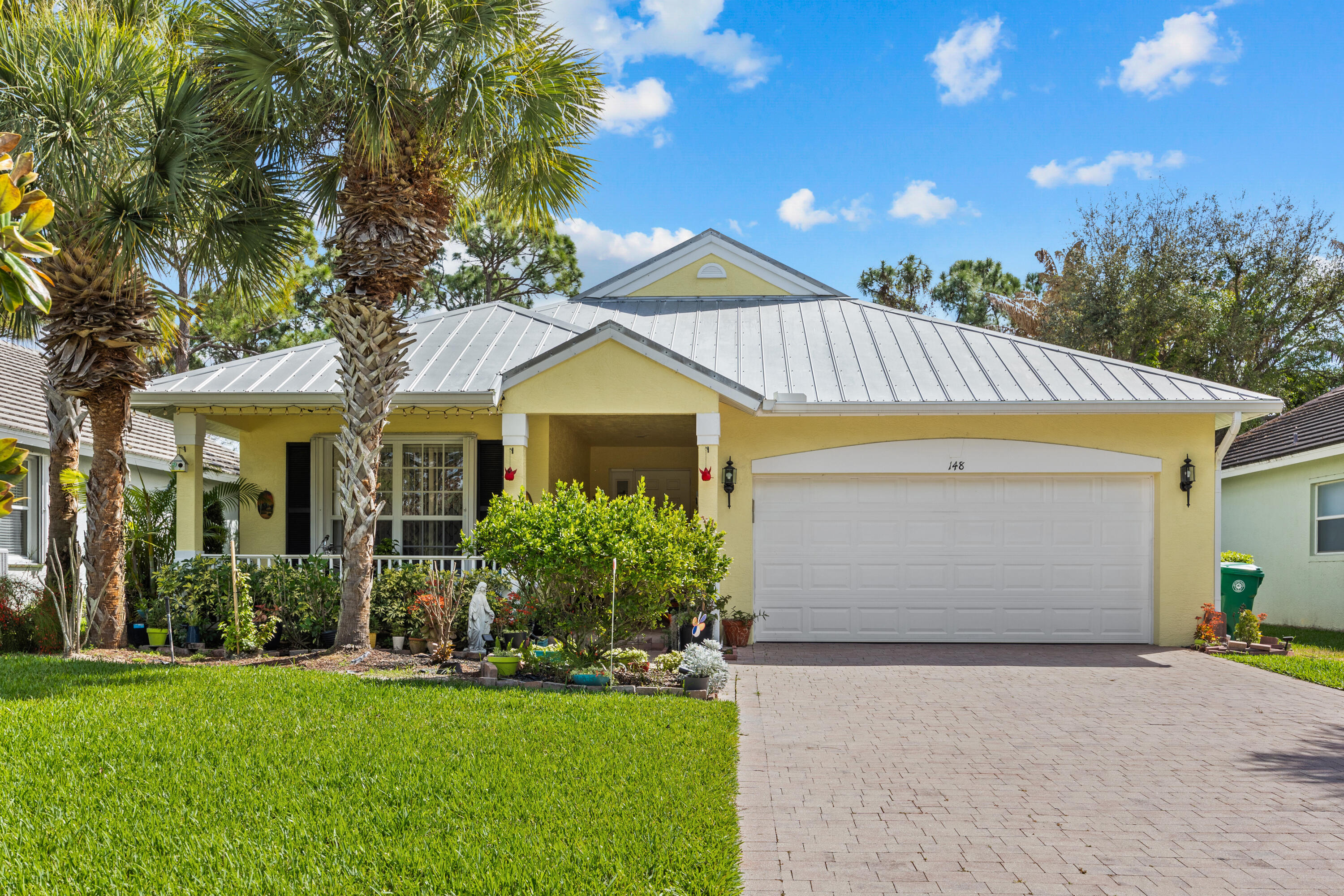 Welcome to this charming 3 bedroom 2 bathroom home located in the gated community of Magnolia Lakes in St Lucie West! Exterior features an extended paver driveway, 50 year metal roof, covered front porch, private screened back patio surrounded by lush foliage and white PVC fencing, full hurricane protection with accordion shutters. Inside you'll find high/vaulted ceilings, tile throughout main living areas and luxury vinyl flooring in the bedrooms. Eat-in kitchen with updated soft close cabinetry, pantry and plenty of countertop space. Spacious master bedroom with 2 walk-in closets, his/her vanities & soaking tub. No front neighbors with a nature preserve out front. Community clubhouse offers extensive amenities. Close to shopping and transportation.