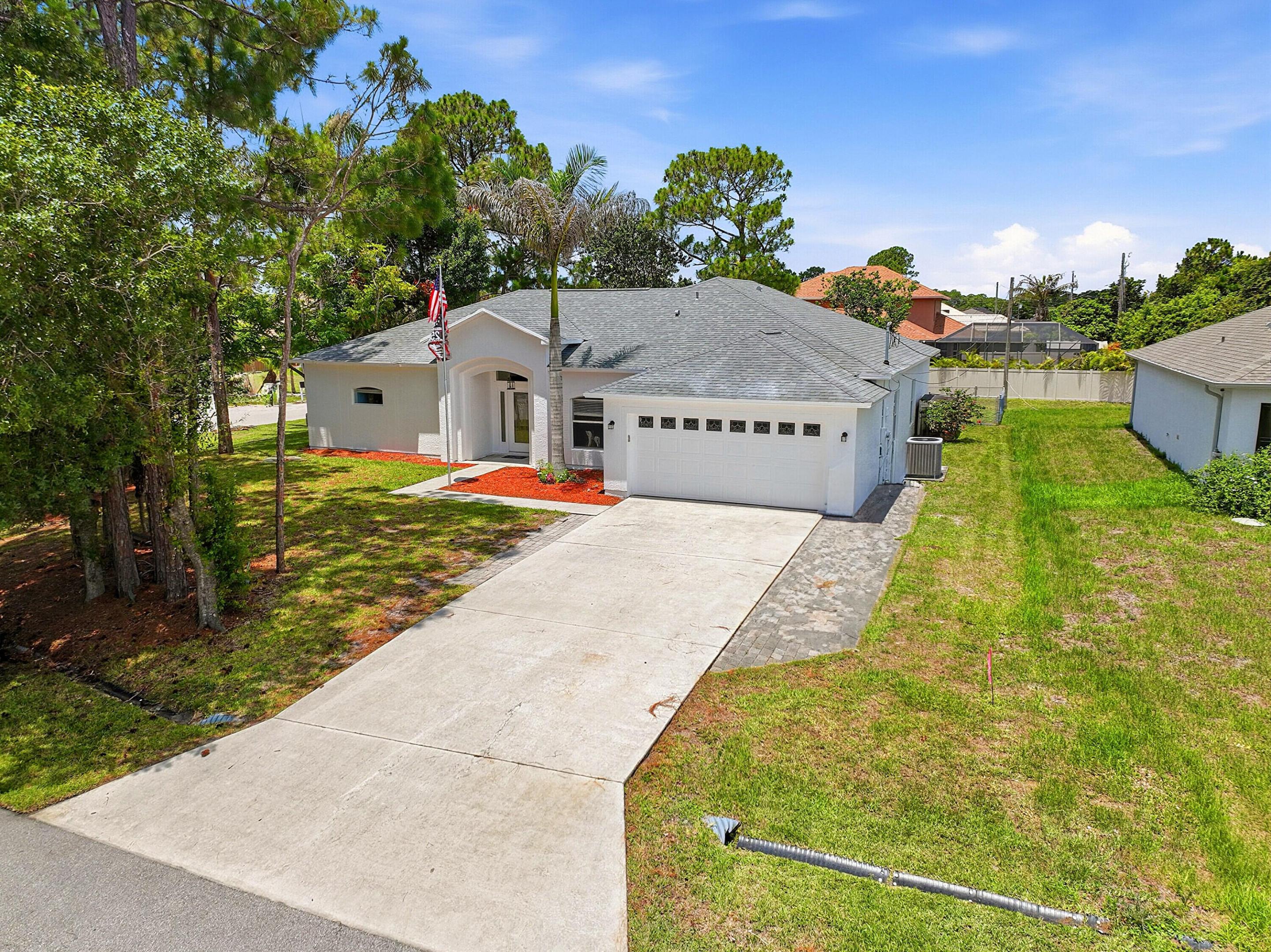 Welcome to this spacious three-bedroom, two-bathroom single-story residence in Port St. Lucie offering 2,388 square feet of comfortable living space. Newer roof and freshly painted. This single-family home features practical amenities including a two-car garage for convenient vehicle storage and protection. The open floor plan provides flexibility for various living arrangements and entertaining needs. Located in Port St. Lucie, this property presents an excellent opportunity for those seeking a well-proportioned residence with functional design and ample square footage.