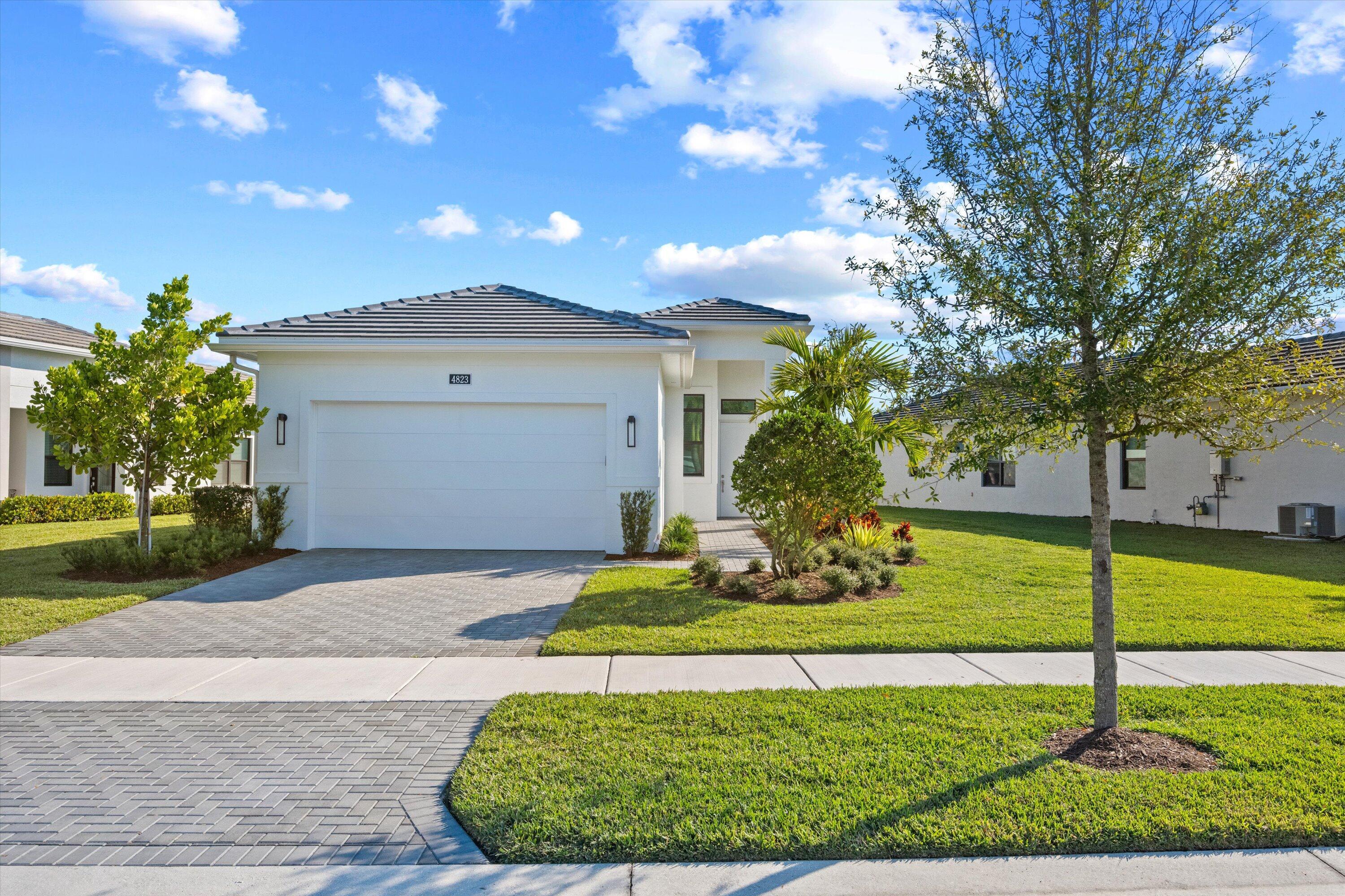 Beautifully furnished 3BR/2BA waterfront home with den in the desirable Cresswind Palm Beach community. This immaculate property offers an open-concept layout with upgraded tile, a stunning granite kitchen island, and a fully supplied kitchen. Living area includes a decorative fireplace, TV, and comfortable furnishings, plus a cozy dining space. The den provides an ideal office or flex room. The split-bedroom design includes one room with twin beds and another with a full bed and nightstands, serviced by a full bath. The carpeted master suite features a queen bed, TV, large walk-in closet, dual sinks, private water closet, and spacious walk-in shower with tile to the ceiling. Patio furniture included for enjoying serene waterfront views.