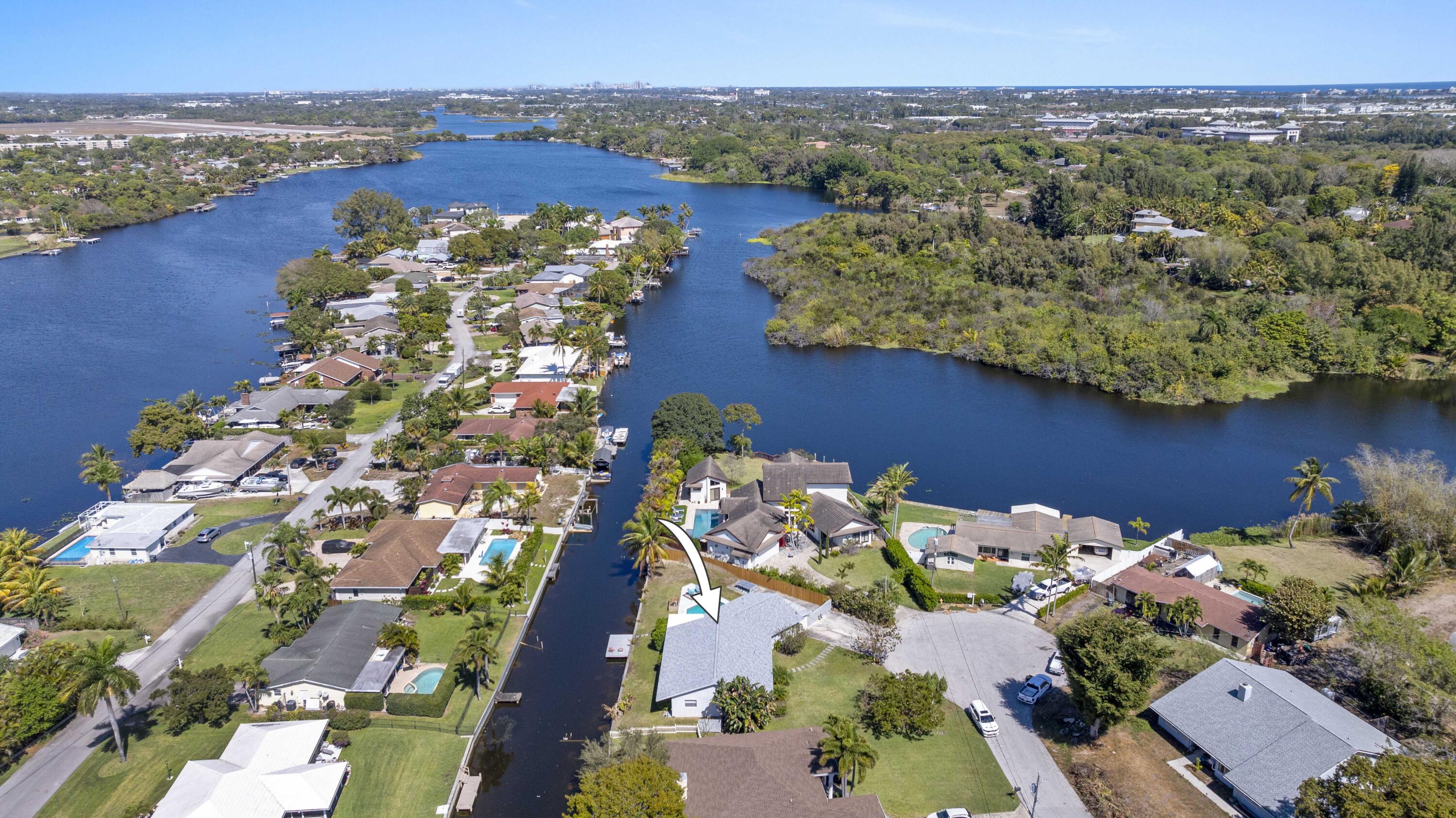 Welcome to waterfront living at its finest at 6797 Bayshore Drive in Lake Worth. Perfectly positioned on an expansive 11,720 square foot lot, this beautifully updated residence captures the essence of South Florida's relaxed luxury lifestyle, where everyday living feels like a private retreat.

Offering 3 bedrooms, 3 bathrooms, and 2,513 square feet of interior living space, the home has been thoughtfully renovated with comfort and quality in mind. A brand new roof, installed in 2025 and accompanied by a warranty, provides peace of mind for years to come, while freshly painted exterior walls and trim completed the same year create a crisp, move in ready presentation. Inside, the home showcases major upgrades throughout. The custom designed kitchen, renovated in 2020, features bespoke cabinetry paired with stainless steel KitchenAid Pro appliances, including a convection oven and induction glass top stove, blending modern performance with timeless design. Beautiful 30 by 30 porcelain flooring flows seamlessly through the main living areas, enhancing both durability and visual appeal while reflecting natural light from the waterfront backdrop.

Step outside to experience what truly sets this property apart. The backyard opens to tranquil waterfront views and features a beautiful in-ground pool, creating an ideal setting for entertaining, relaxing poolside, or launching a kayak at sunrise. Framed by swaying coconut palms and a blooming banana tree, the outdoor environment feels lush, private, and distinctly Floridian.
Positioned on a navigable lake, this property offers the rare ability to operate a boat, jet skis, and enjoy a full range of water activities right from your backyard. Whether it's sunset cruises, paddleboarding, fishing, or spending weekends on the water, this is true lifestyle-driven waterfront living.

This is more than a home. It is a lifestyle defined by water, nature, and effortless indoor-outdoor living. Offering exceptional value for a true waterfront property, the location places you just moments from West Palm Beach and Delray Beach, providing convenient access to world-class dining, shopping, and coastal attractions while maintaining a peaceful residential setting.
A rare opportunity to secure renovated, lakefront living with land, upgrades, and lifestyle all in one.