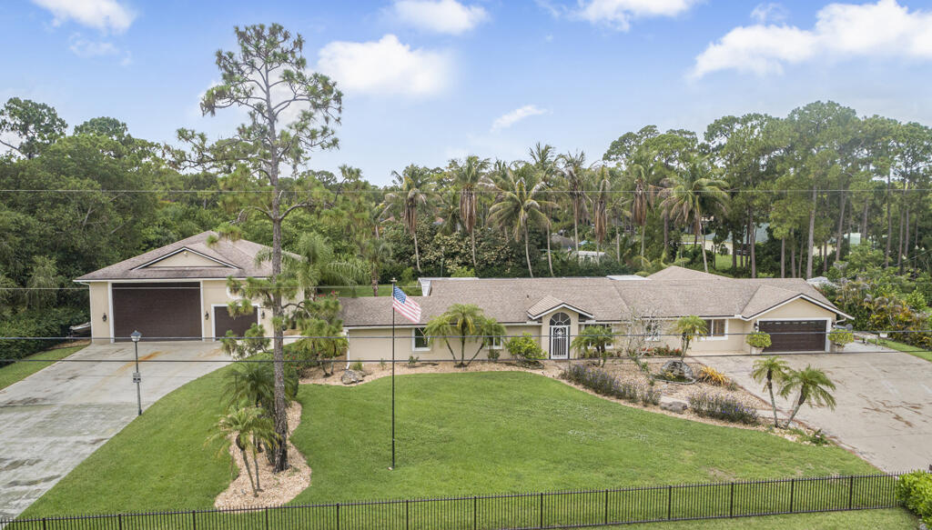 Discover this spacious single-family residence in Loxahatchee, offering 2,547 square feet of finished living space across one story. The home features five generous bedrooms with 2 master bedrooms and three full bathrooms, providing ample accommodation and convenience for varied needs. A 6 car detached- garage shop with office buildout inside ensures secure vehicle parking and additional storage for large boat or RV. Relax in your backyard that offers resort style pool with outdoor full kitchen. Large private pool side bar that is perfect for family parties with tons of room! Other features include stainless steel appliances granite counter tops and large family size kitchen. Full impact window protection. 2 separate driveways. Call listing agent to setup your appointment today.