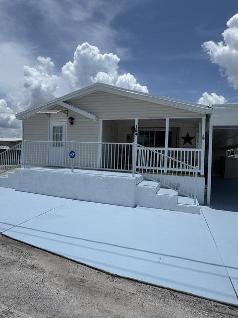 Level up your Florida coastal lifestyle in this spacious 3BR/2BA split floor plan, the largest model in the community! This well-maintained Manufactured home features new laminate flooring, fresh exterior paint and skirting, new window screens, storage shed, and a poured concrete handicap-accessible ramp. Major updates include a 2017 roof with a transferable 15-year warranty, whole-house generator, 3 propane tanks, 2020 water heater, whole-house ADT security system, and a 6-month service plan for the generator and HVAC. Ownership includes a share in the Co-Op with a low $255/month HOA and NO LOT LEASE! Move-in ready and perfectly suited for year-round living or your Florida getaway. Recent improvements include new laminate flooring, fresh exterior paint and skirting, new window screens, and a convenient storage shed. Major system updates provide added confidence, including a 2017 roof with a transferable 15-year warranty, whole-house generator, three propane tanks, 2020 water heater, and a whole-home ADT security system. For added convenience, the generator and HVAC are currently maintained on a six-month service plan. Designed with accessibility in mind, the home features a poured concrete handicap-accessible ramp, making entry easy and accommodating a variety of lifestyle needs. The spacious split-bedroom layout provides privacy for owners and guests alike, while the generous living areas offer plenty of room to relax or entertain.  Best of all, ownership includes a share in the Co-Op, meaning NO lot lease! Enjoy one of the area's most affordable ownership opportunities with a low $255/month HOA, allowing you to embrace the Florida coastal lifestyle without the high monthly costs.