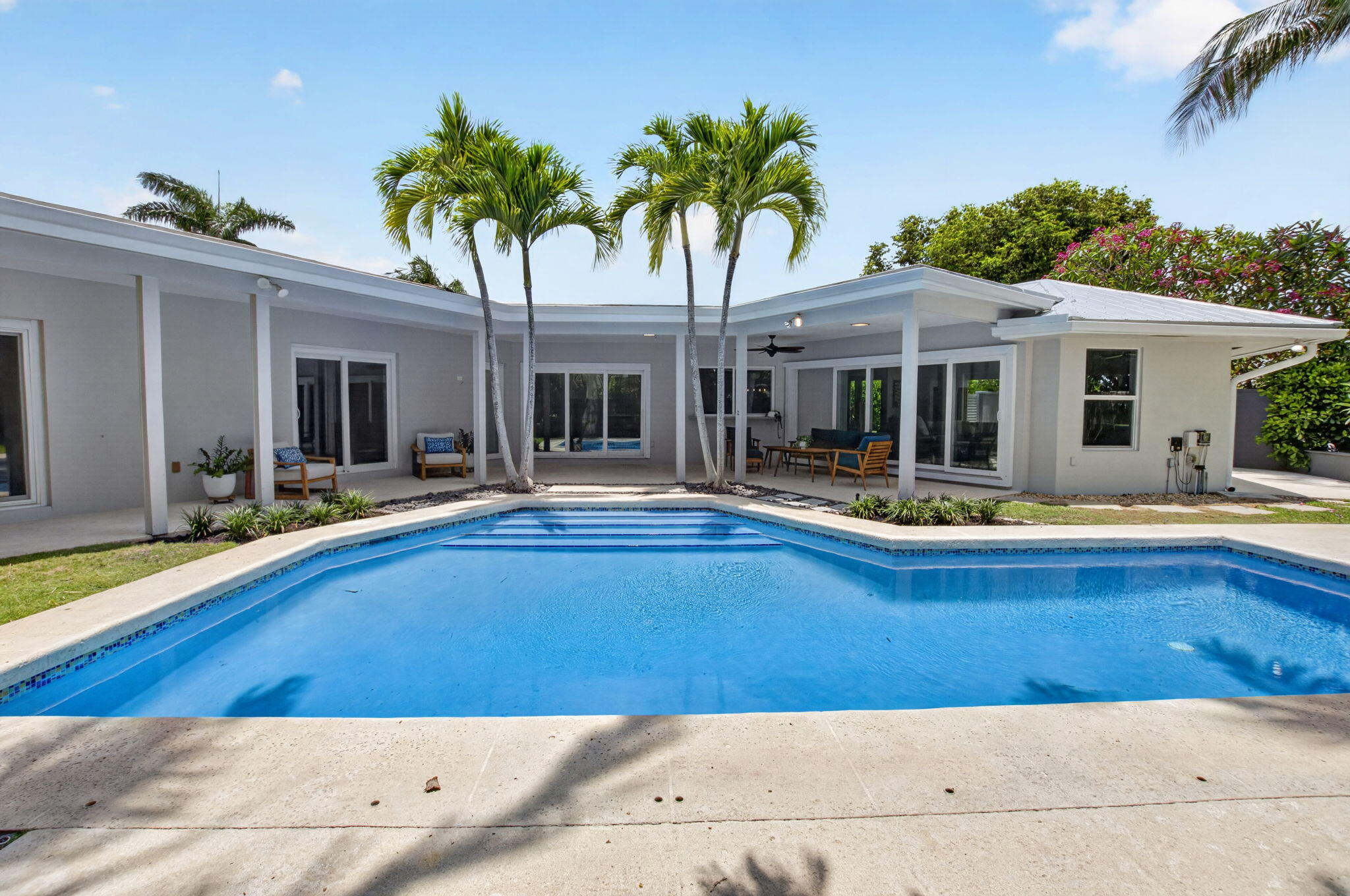 Exceptionally renovated and meticulously maintained, this stunning one-story residence in sought-after Lake Ida / Lake Shore Estates truly has it all. Perfectly positioned on a private .35-acre cul-de-sac lot, this home offers the ideal combination of luxury, comfort, and functionality with 3 bedrooms, a spacious den/office, and 3 full bathrooms. Adding to its unique appeal, the home was originally designed by renowned late Delray Beach architect Roy Simon for his brother, reflecting the legacy of a designer known for several notable local landmarks.  From the moment you enter, you'll appreciate the quality craftsmanship and thoughtful upgrades throughout, including porcelain tile flooring, smooth-finish walls, impact windows and doors, and a full-house generator for complete peace of   mind.  The heart of the home is the spectacular chef's kitchen, featuring custom solid hickory center island topped with quartzite, elegant two-tone cabinetry, dual sinks, two Wolf ovens, a Wolf induction cooktop, and a stunning hammered copper farmhouse sink. A convenient pass-through window, abundant natural light, and direct views of the sparkling blue pool create the perfect indoor-outdoor lifestyle.  The spacious primary suite serves as a private retreat with direct access to the patio and pool area, tranquil backyard views, a custom walk-in closet, and a beautifully designed ensuite bath complete with a walnut double vanity and oversized frameless glass shower.  A substantial den/office/media room addition provides exceptional flexibility, whether working from home, hosting movie nights, or creating a playroom. Two additional guest bedrooms and two full guest bathrooms offer ample accommodations for family and visitors.  Step outside to your own private backyard oasis. Fully enclosed for privacy, the outdoor space features a beautifully renovated pool completed in 2026, lush green lawn areas, and abundant room for entertaining, all enhanced by desirable southern exposure.  Boating enthusiasts will appreciate the unique oversized garage design featuring dual garage doors that allow for easy drive-through access. A dedicated concrete boat pad with a custom wood-framed cover provides protected storage for your boat and toys, a rare and valuable feature.  This move-in-ready Lake Shore Estates gem offers exceptional upgrades, versatile living spaces, and an unbeatable private setting—an extraordinary opportunity to enjoy the very best of Florida living.